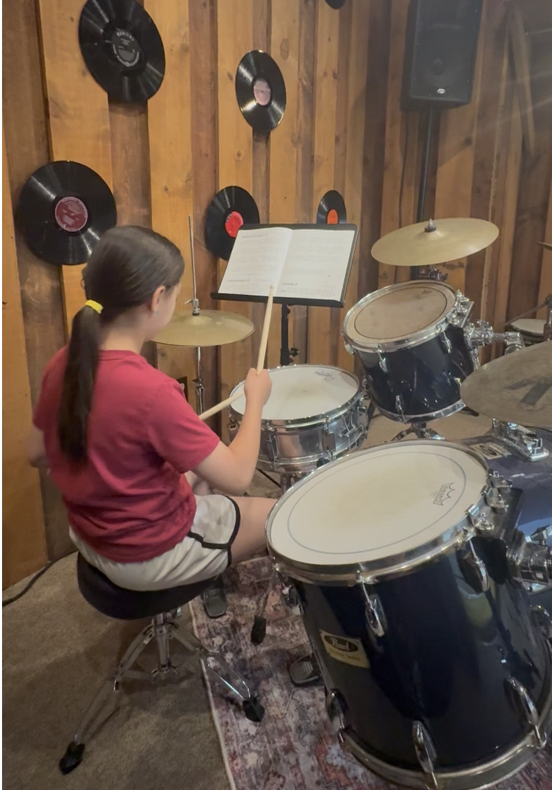 Young girl taking drum lessons at Rhythm and Strings music studio in Billerica MA