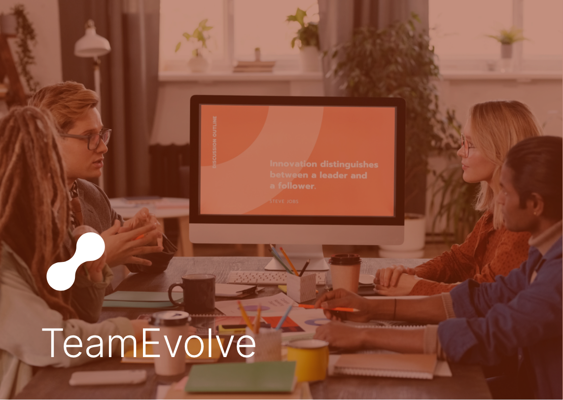 TeamEvolve: Group of diverse people in a meeting room having a discussion around a table with a computer monitor displaying a quote about innovation.