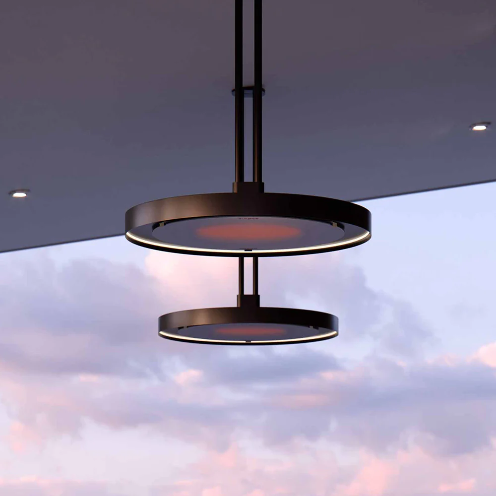 Modern circular black ceiling lights with a sunset sky in the background.