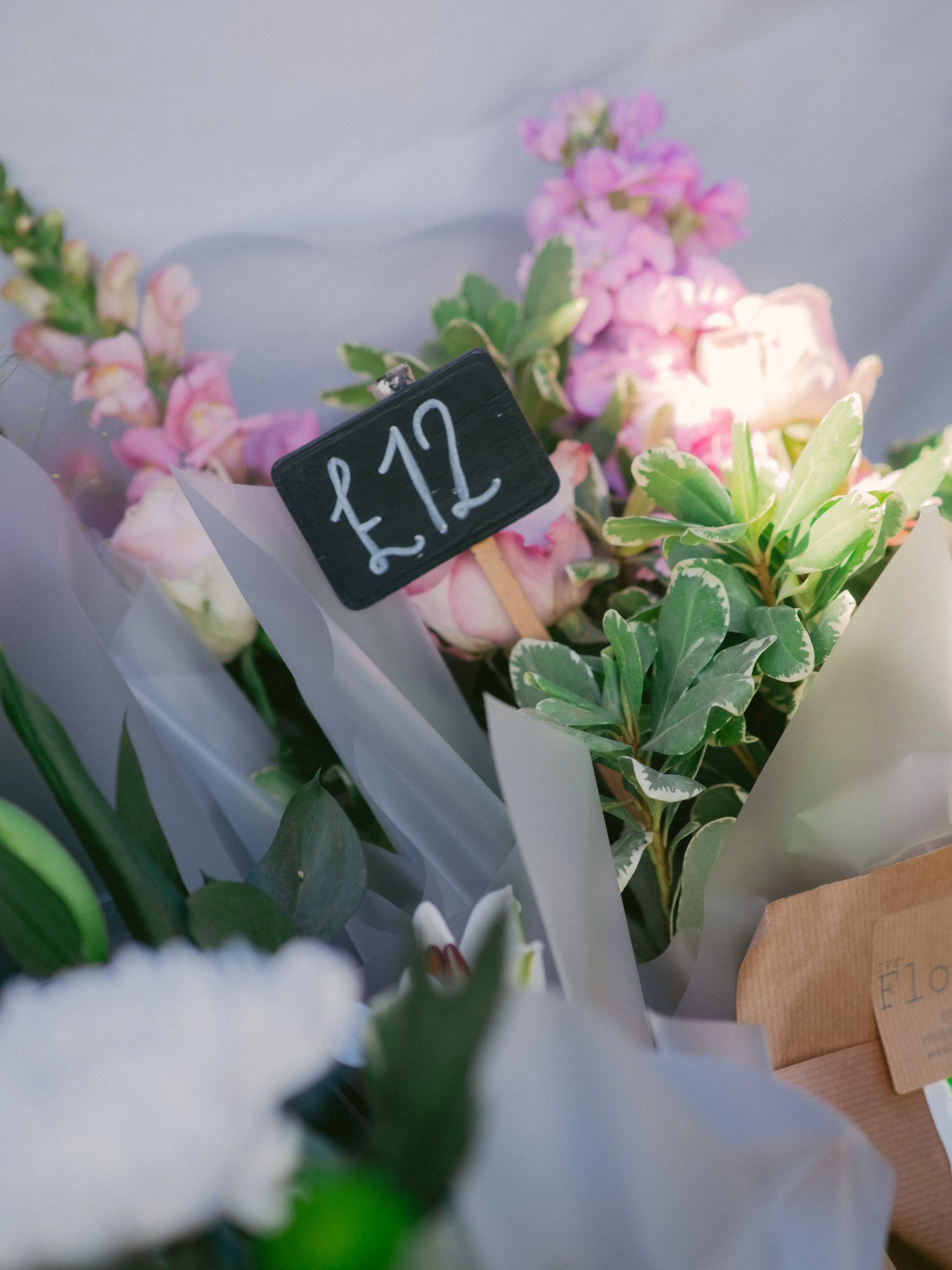 Bouquet of pink and white flowers with a black price tag reading £12.
