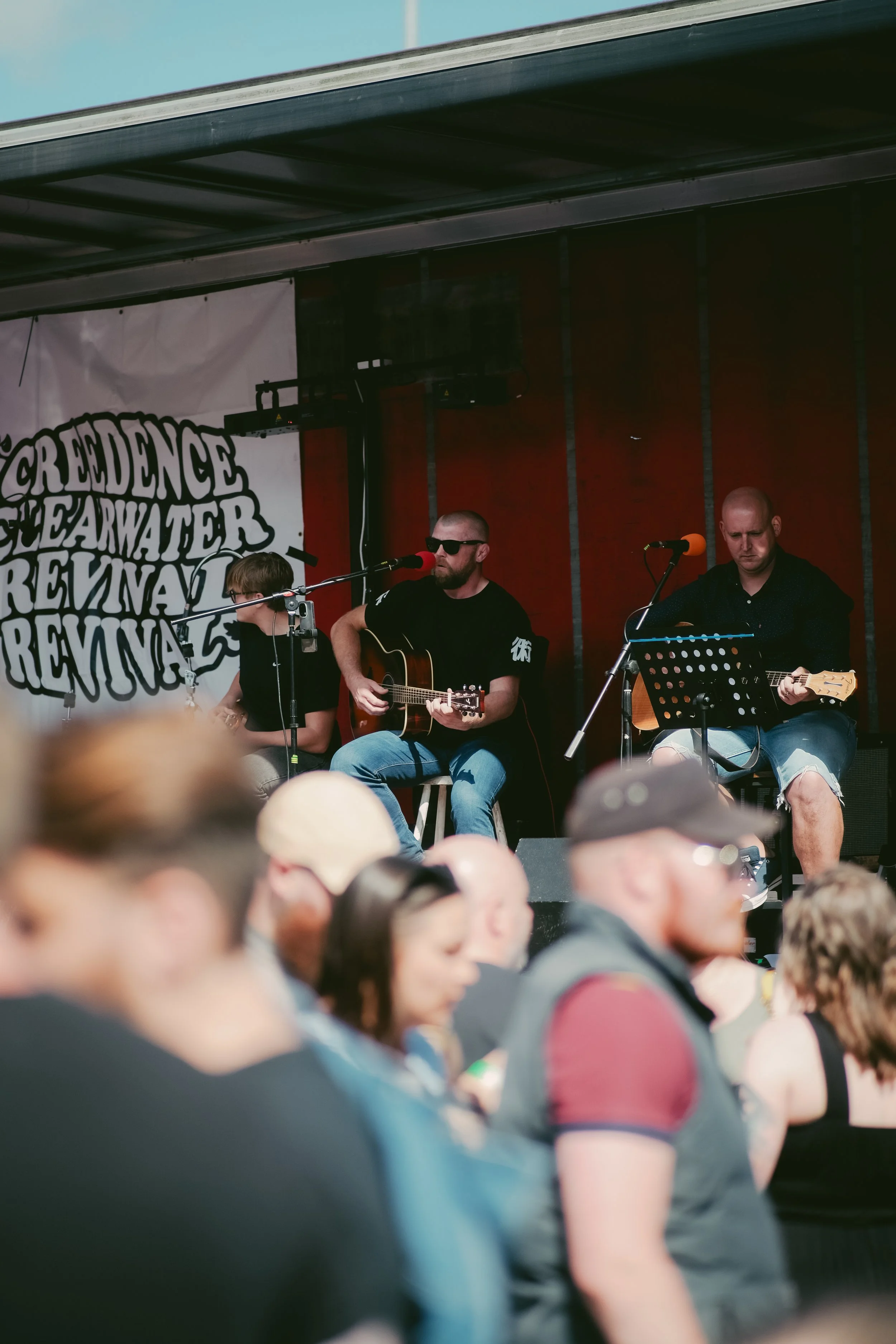 Musicians performing on stage at the Providence Waterfire Revival event, with an audience watching.