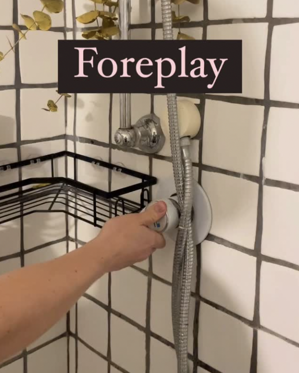 A person is reaching to turn on a shower, with a small shelf and tile background, and the word 'Foreplay' in the image.