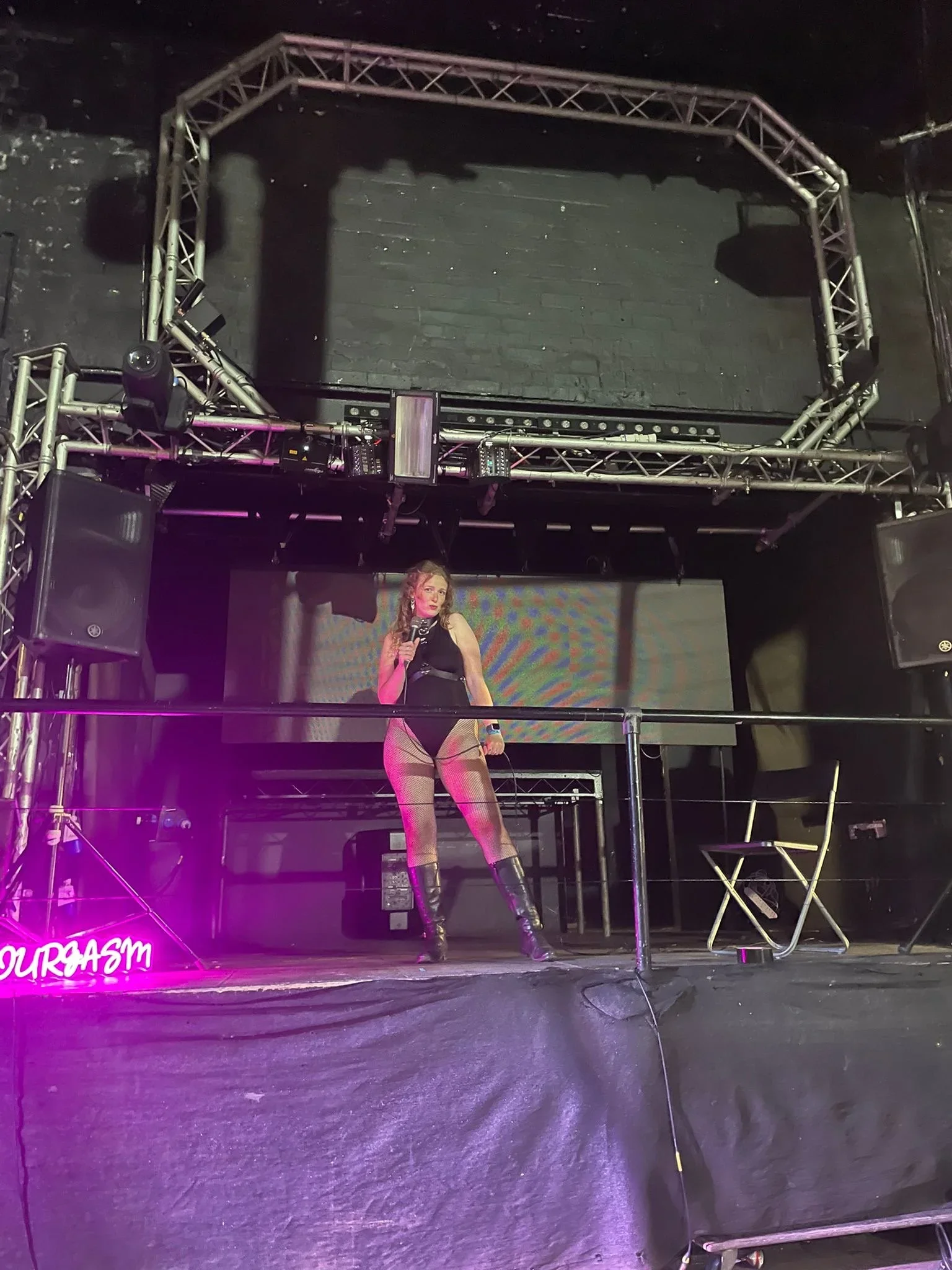 Sarah Peart speaking on stage at a sex festival about pleasure as protest and the history of pleasure