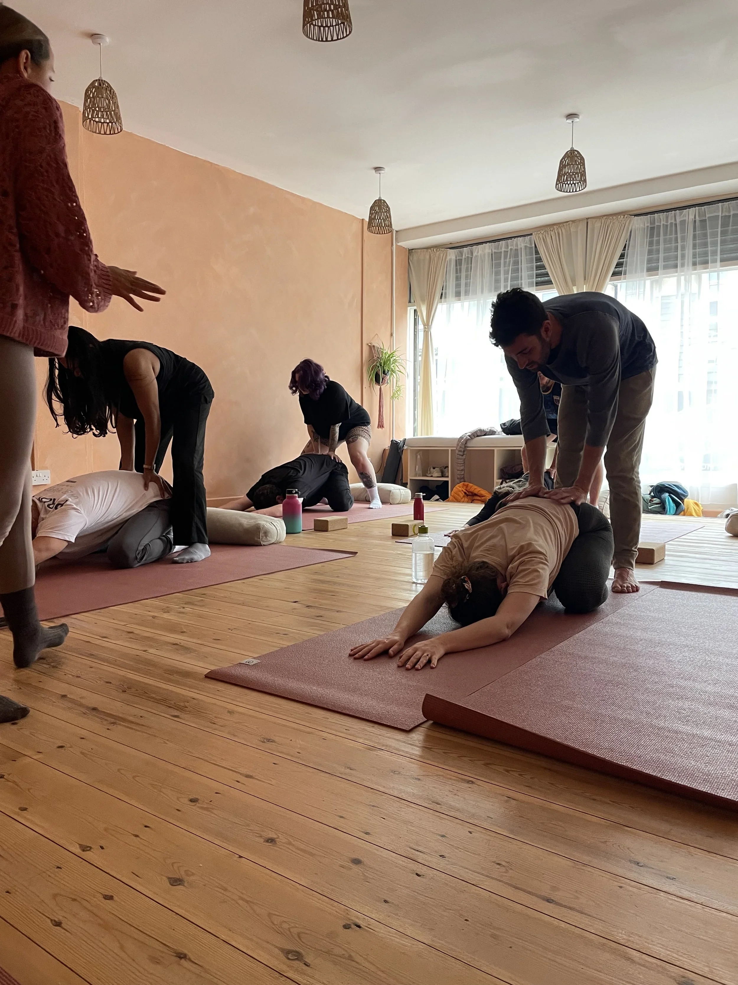 Couples practising partner yoga during an adult intimacy and connection workshop in Brisbane