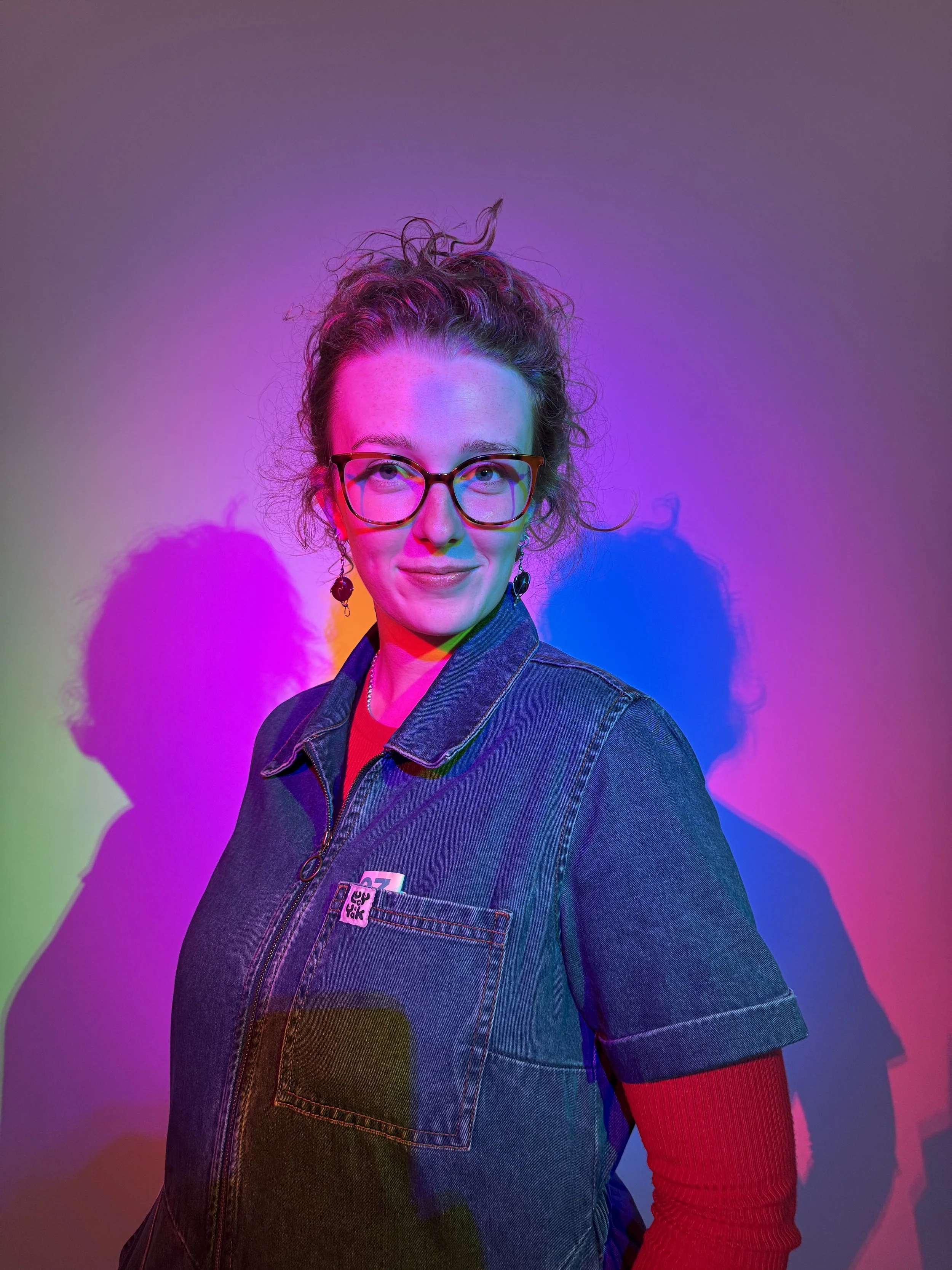 Brisbane sex therapist specialising in neurodivergent sexual health, photographed against a colourful studio background