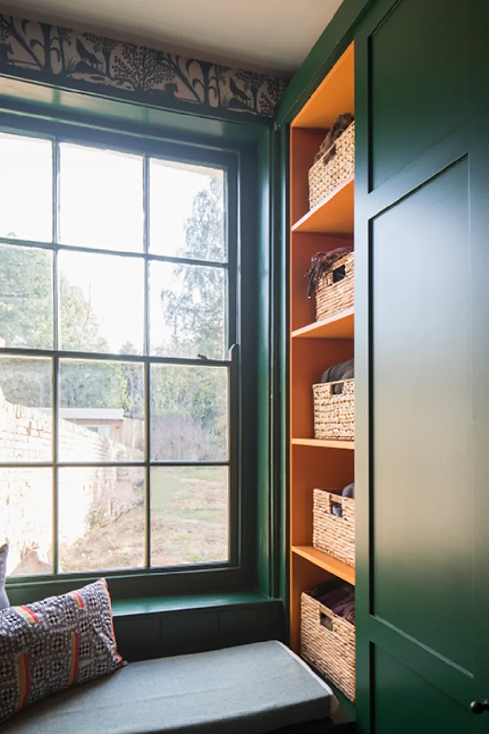 Green-bootroom-with-orange-shelves-interior-design-kent-michelle-shakallis.webp