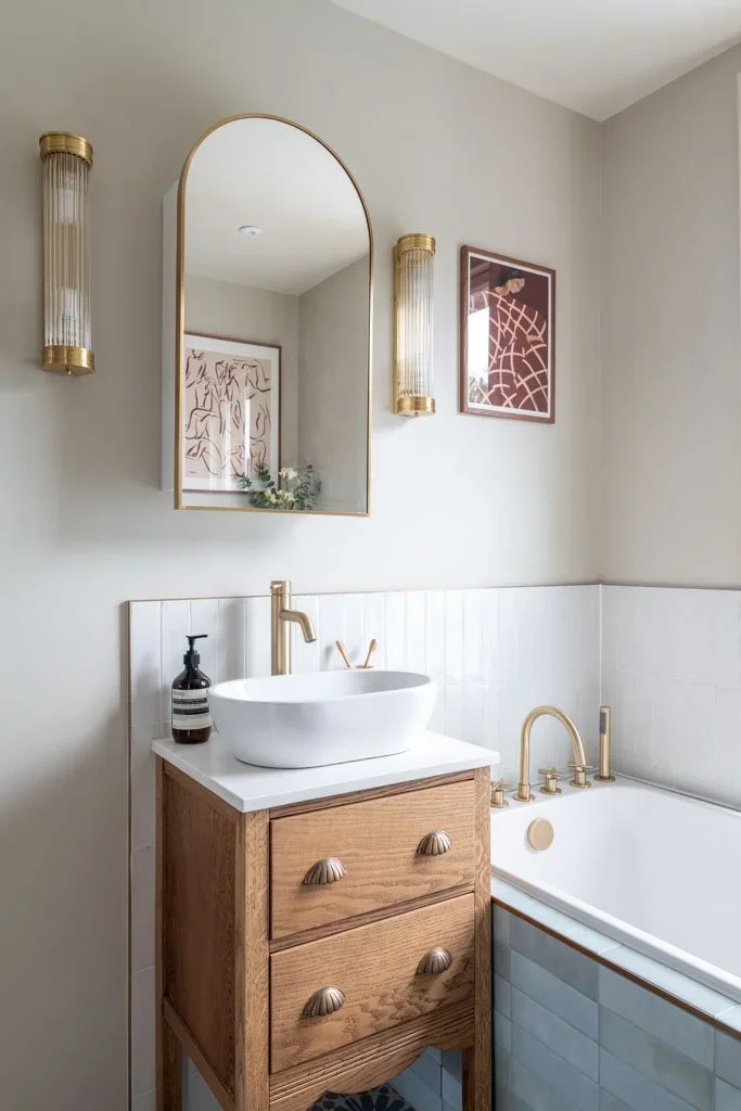 bathroom+vanity+with+art+and+lighting.webp