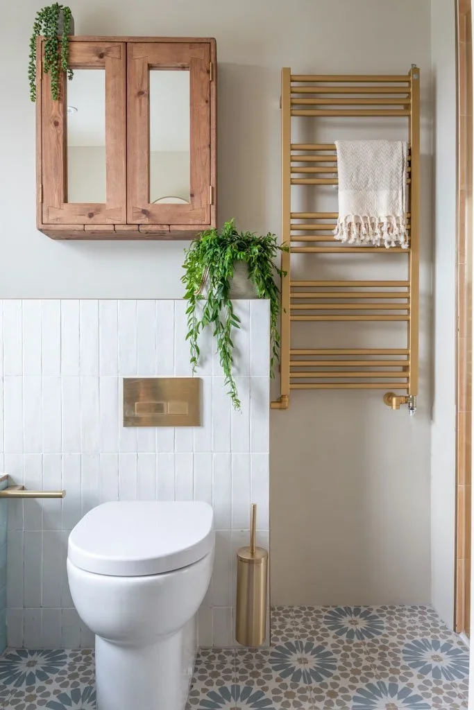 brass+towel+rail+and+patterned+tile+floor.webp