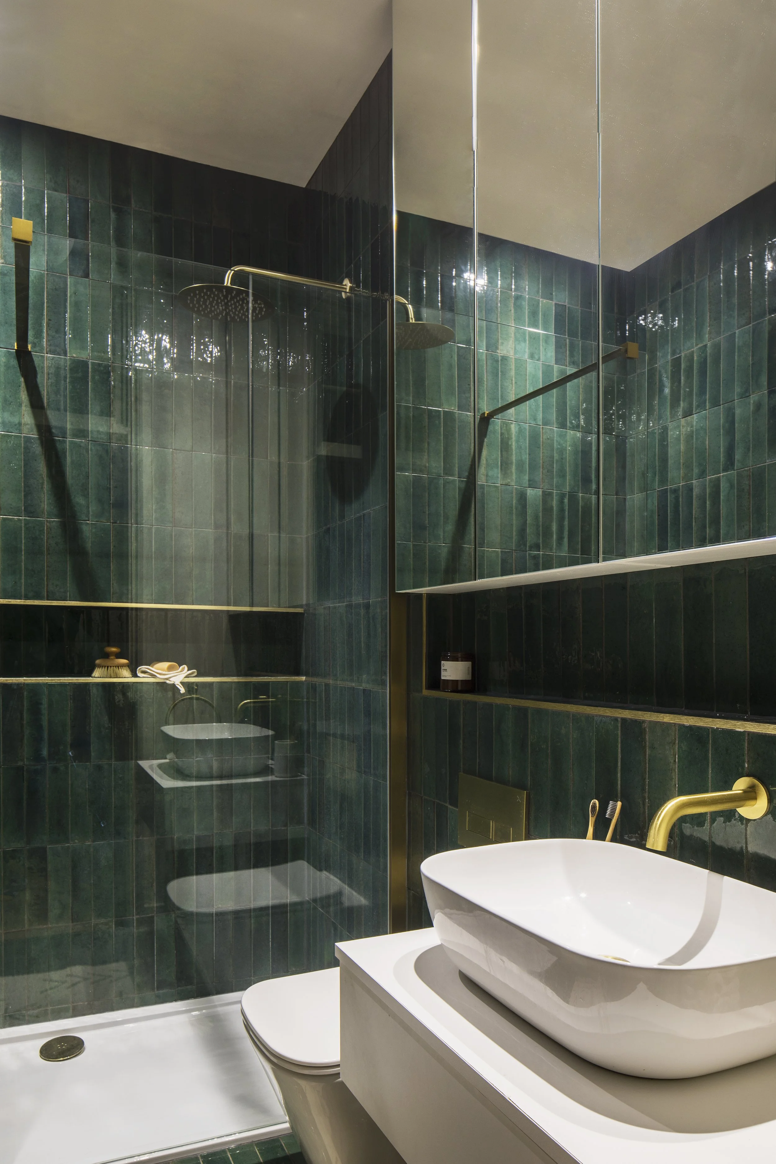 Green tile shower room with mirrored cabinets.jpg
