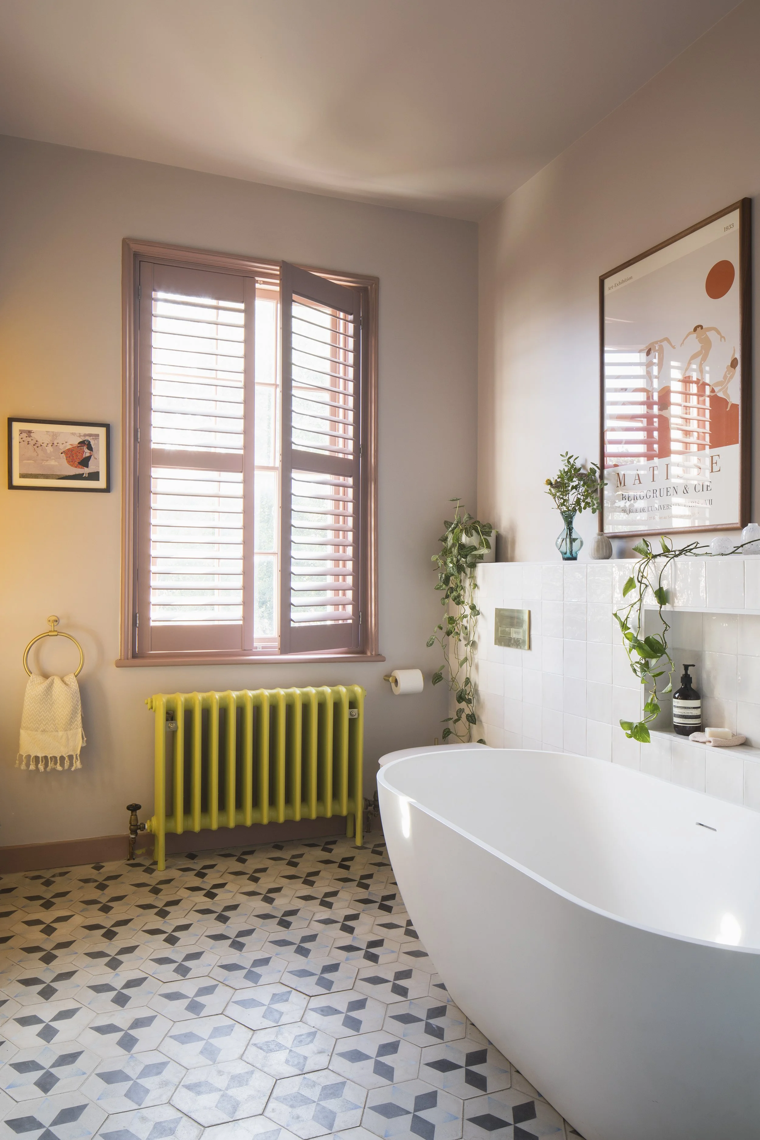 Pink family bathroom with yellow radiator.jpg