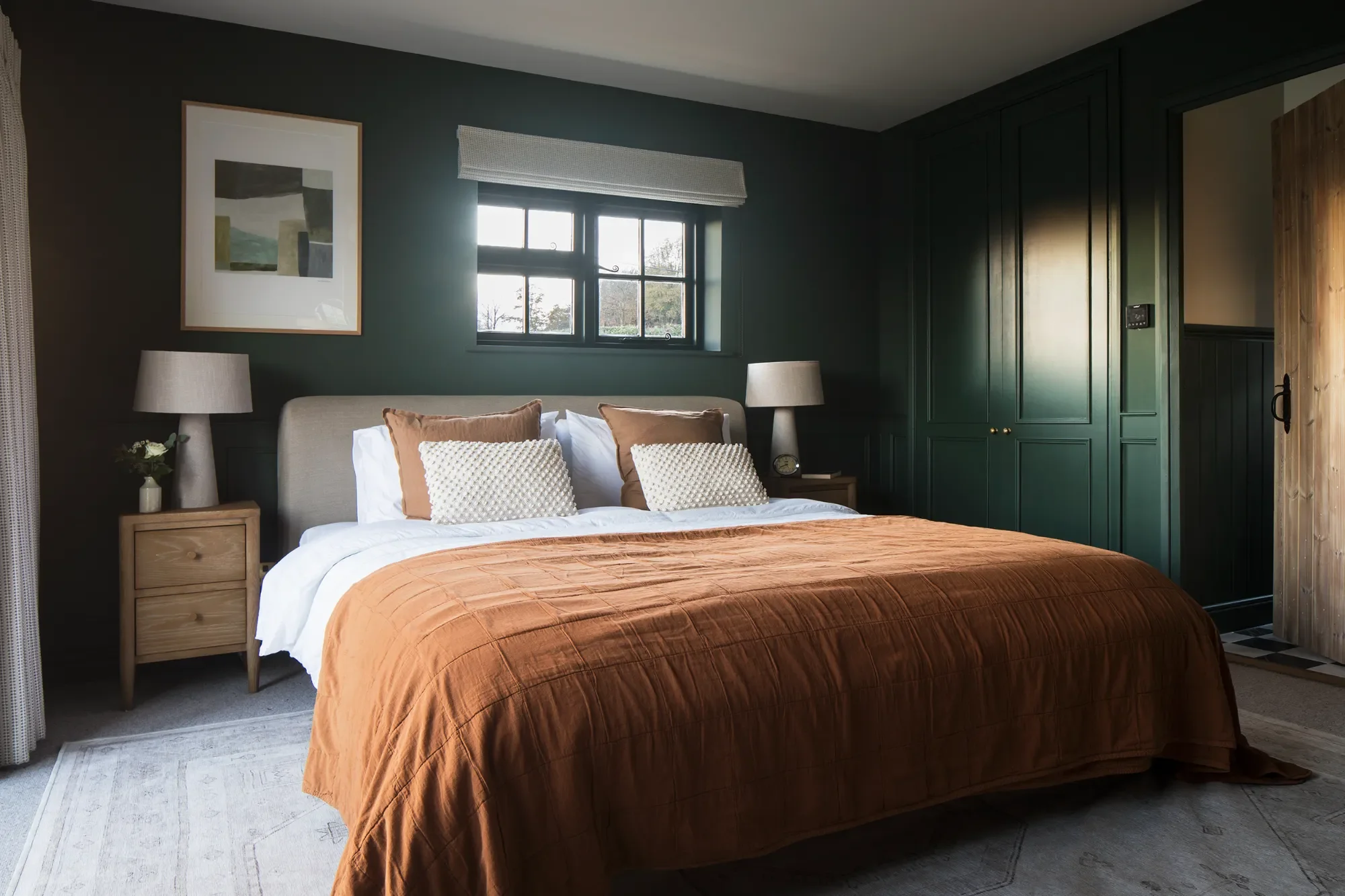 dark-green-bedroom-with-rust-bedding-interior-design-kent-michelle-shakallis.webp