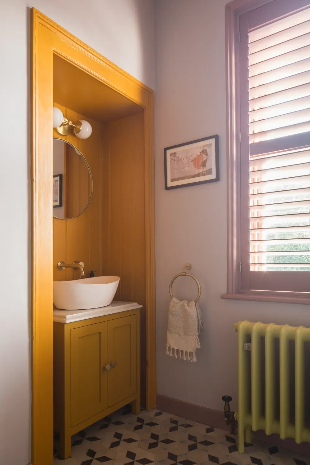 Family-bathroom-with-ochre-alcove-and-pink-window-interior-design-kent-michelle-shakallis.webp