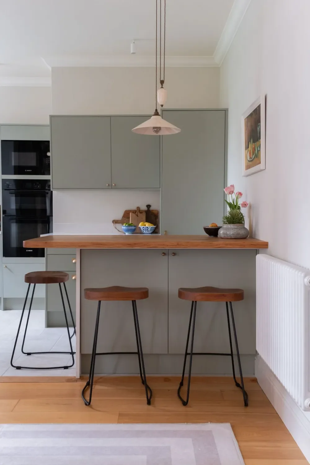 sage kitchen with bar stools Kent Michelle Shakallis Interiors.webp