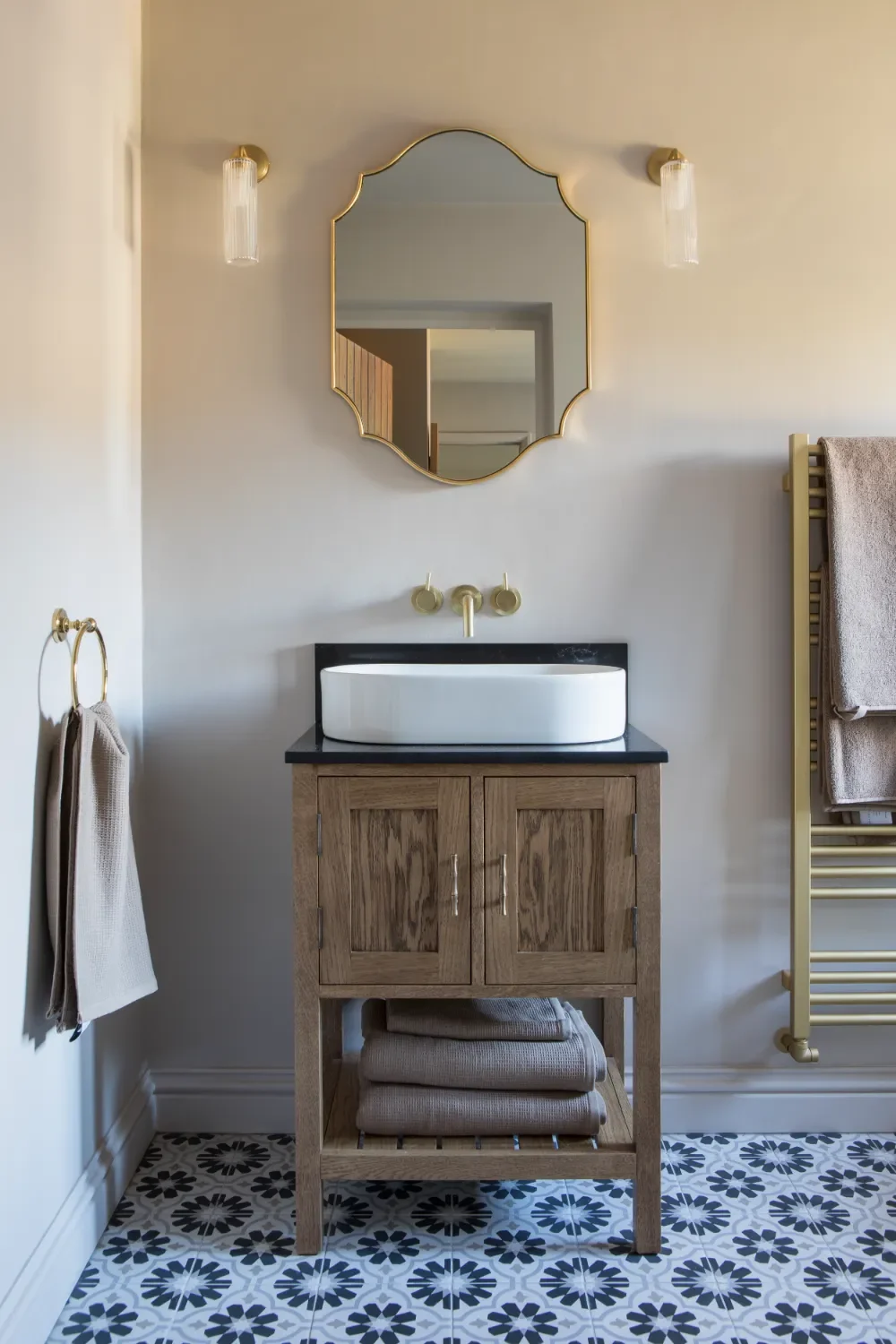 Bathroom-mirror-with-wood-vanity-and-wall-lights-interior-design-kent-michelle-shakallis.webp