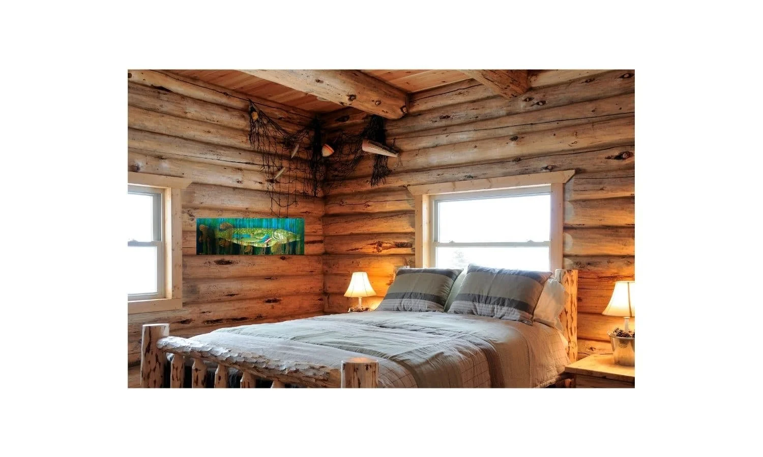 The northern pike painting hanging in a rustic log cabin bedroom showing how the blue and green water colors brighten the wood walls.