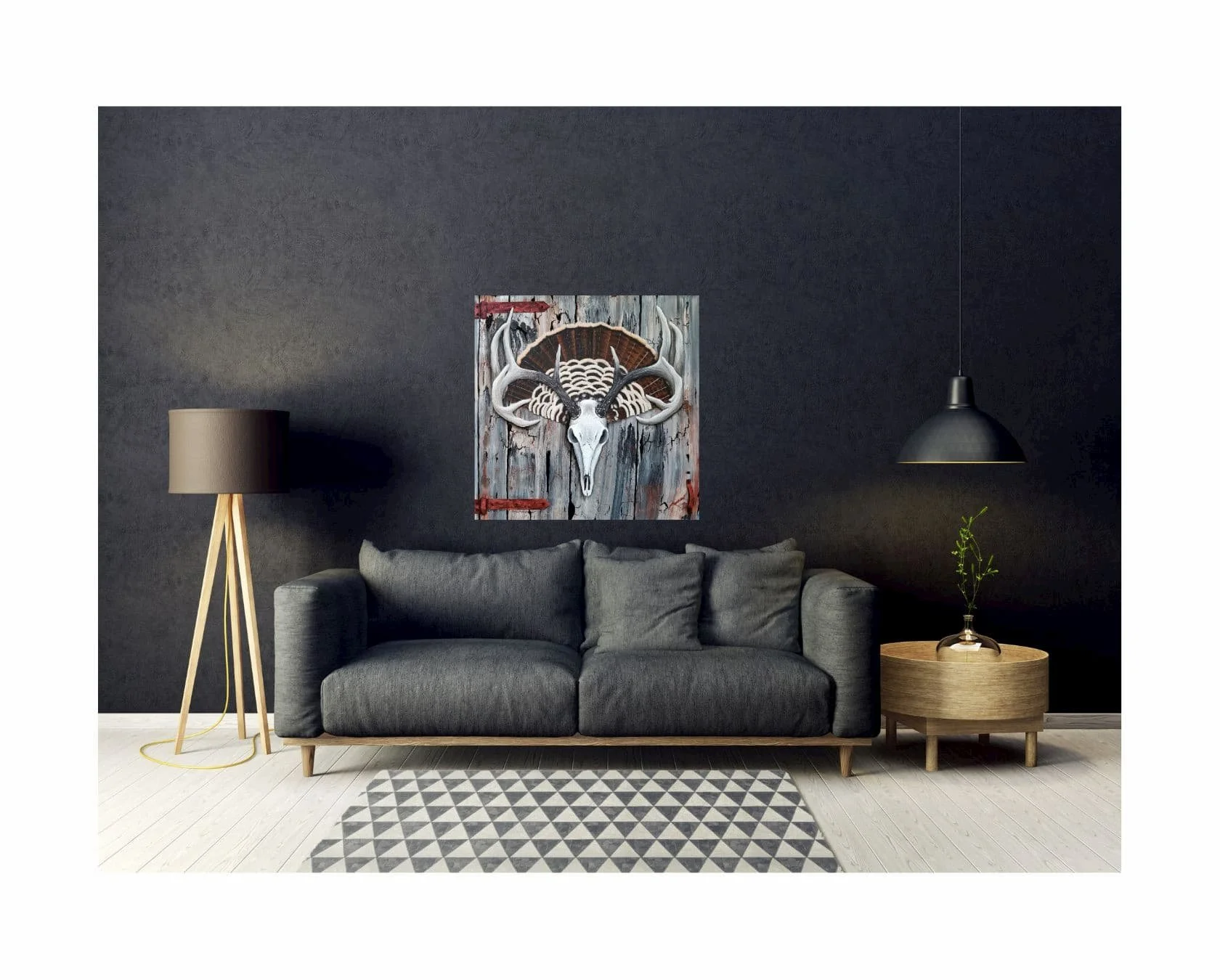 The painting hanging in a modern living room with dark walls, highlighting the contrast between the antlers, turkey tail, and barn wood background.