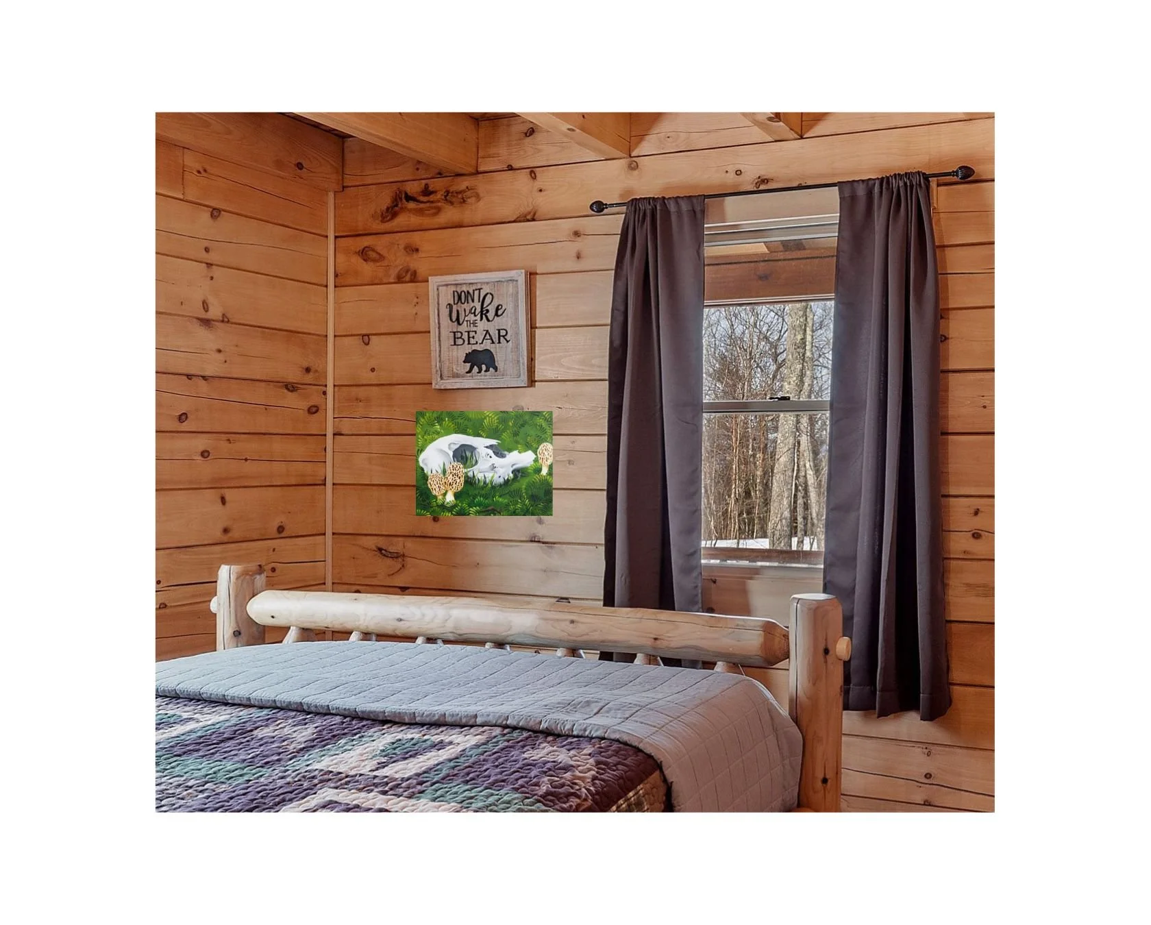 In home mockup of “What Rises” by HL Wirtner hanging in a rustic bedroom with wood paneling and natural light.