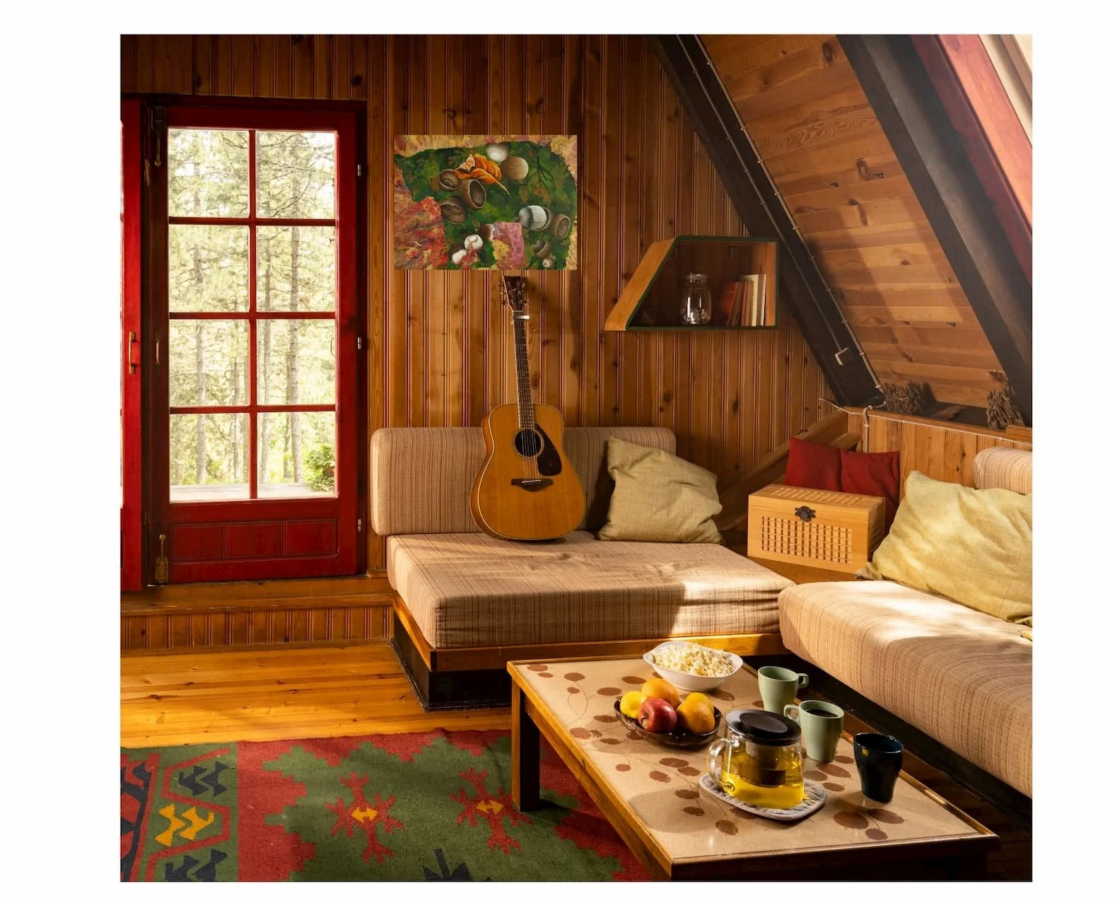 The painting displayed in a rustic cabin living room with natural light, highlighting the greens, acorns, and fall textures.