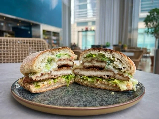 A Southern-style bite with a bold twist. 🥪 
Our Buttermilk Fried Chicken sandwich comes stacked with roasted pepper aioli, jalapeño jack, shredded lettuce, dill pickle relish, and a ranch drizzle, all on a warm rustic roll. 
•
•
&