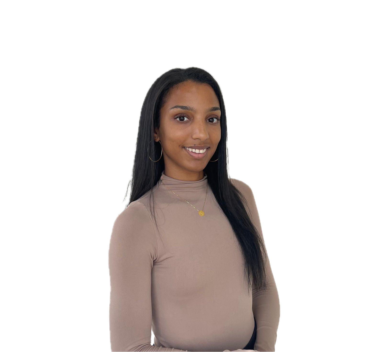 Young woman with long black hair, smiling, wearing a beige turtleneck, gold necklace, and hoop earrings, standing in front of a plain background.