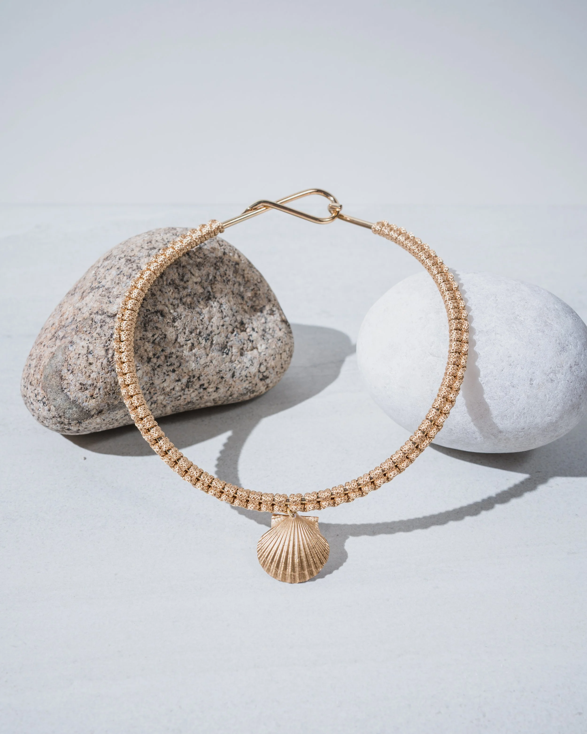 Handmade gold seashell macramé choker necklace with natural cotton cord, perfect for summer beach style.