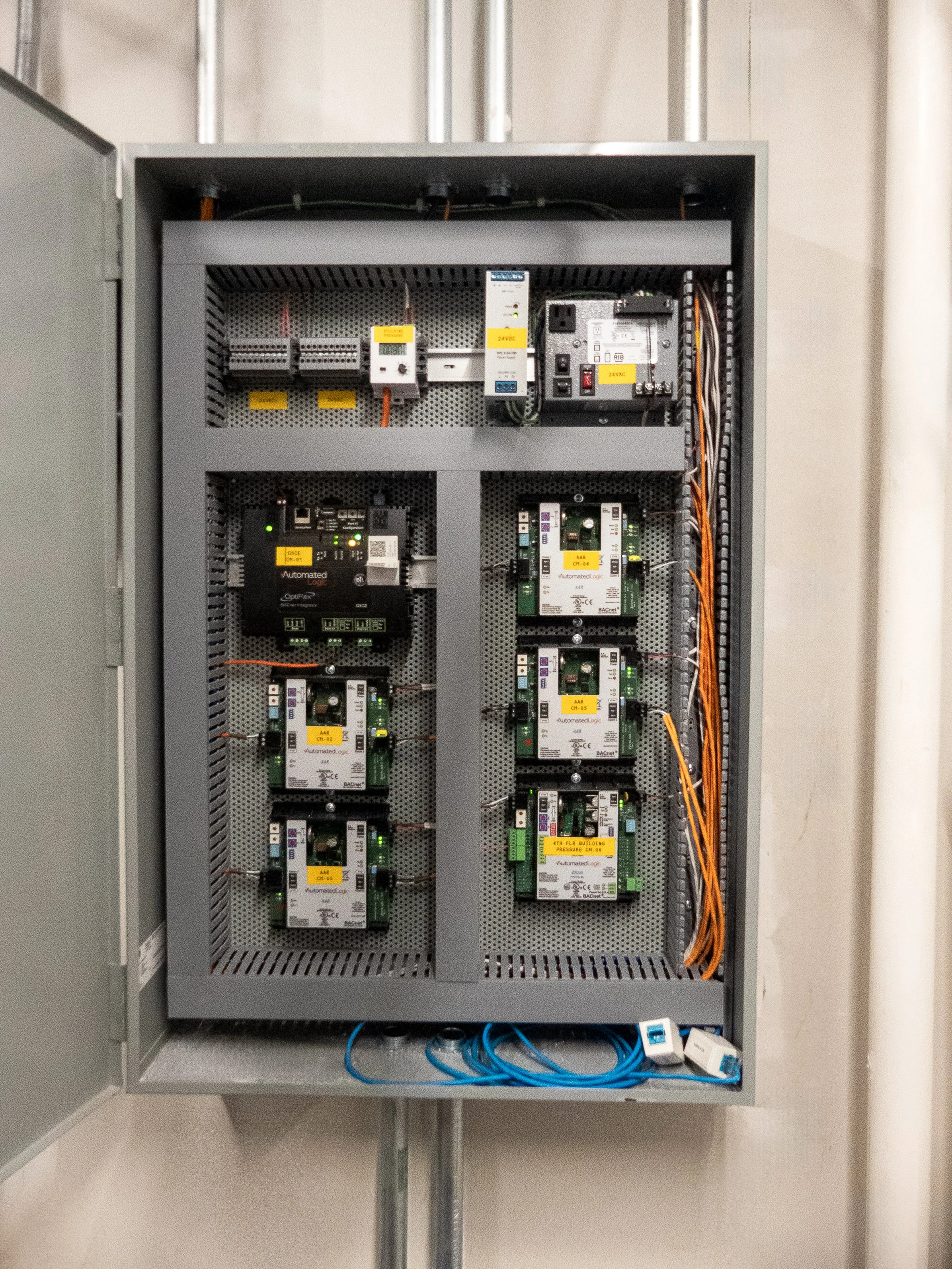 Electrical control panel with circuit components, wiring, and electronic modules.