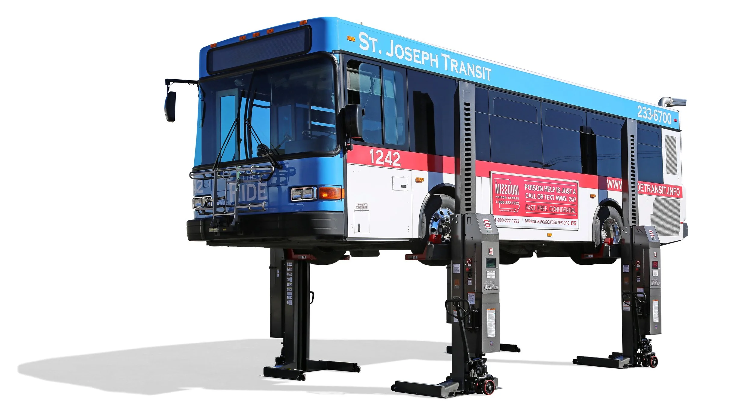 A bus labeled 'St. Joseph Transit' is elevated on hydraulic lifts for maintenance or inspection.