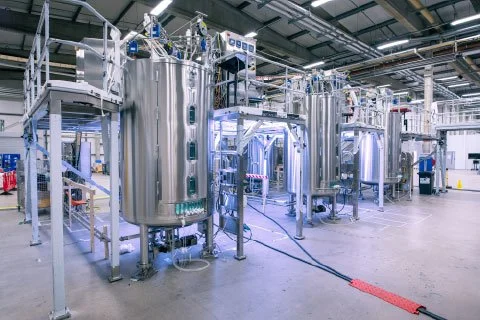 Industrial processing tanks and equipment inside a manufacturing facility.