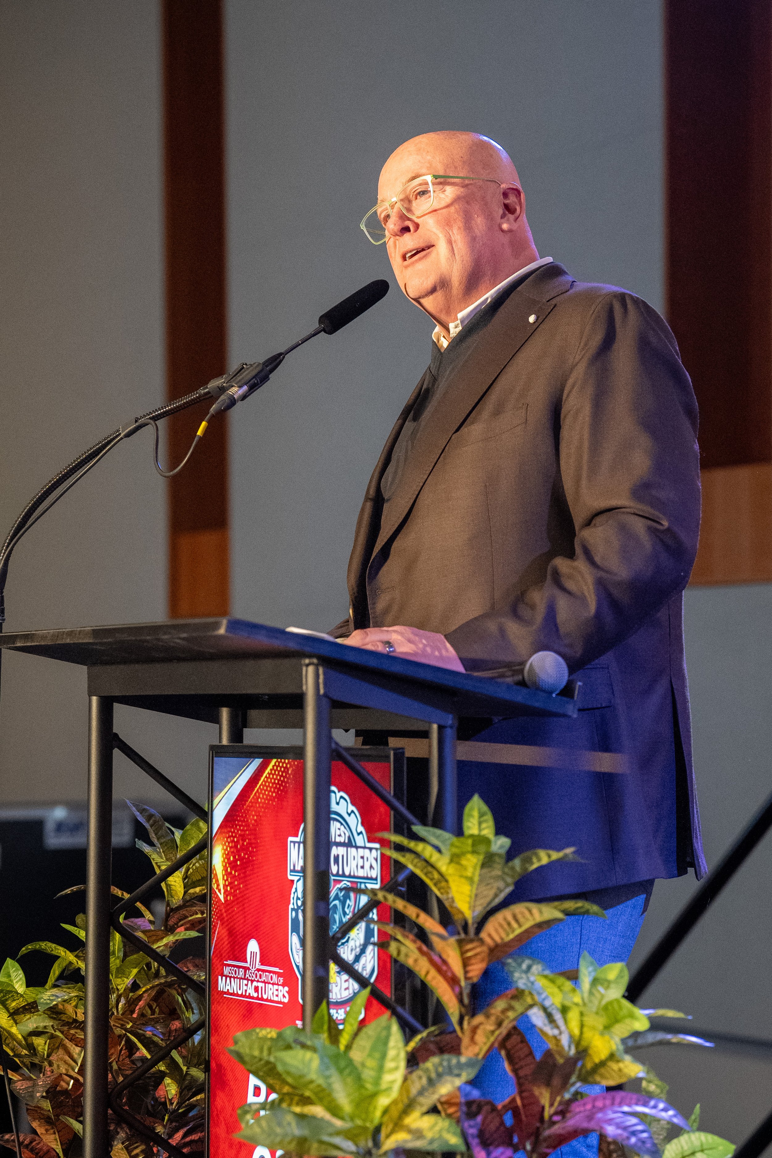 Emcee speaking at podium at live event