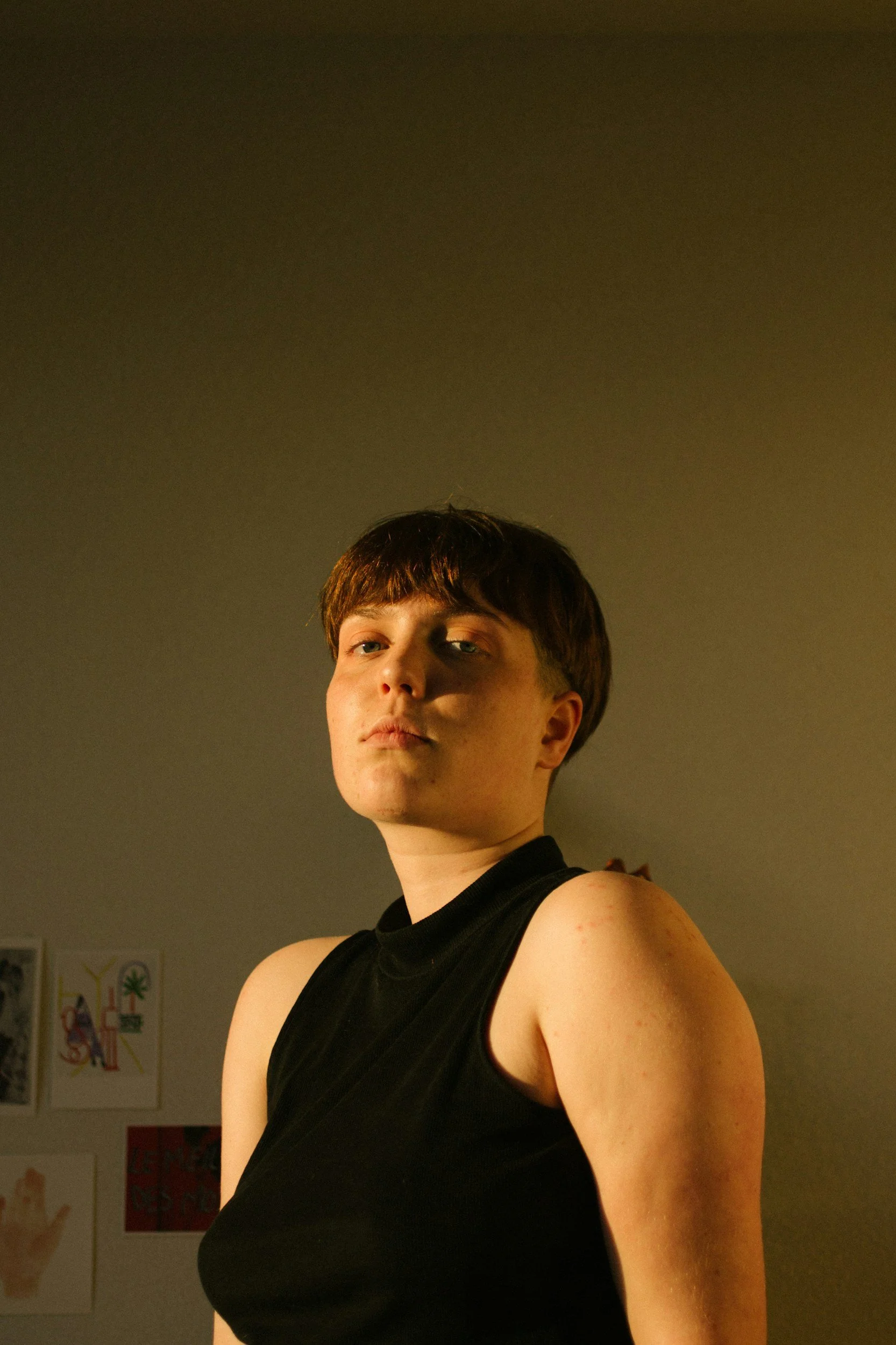 Portrait of a woman with a short haircut wearing a black tank top