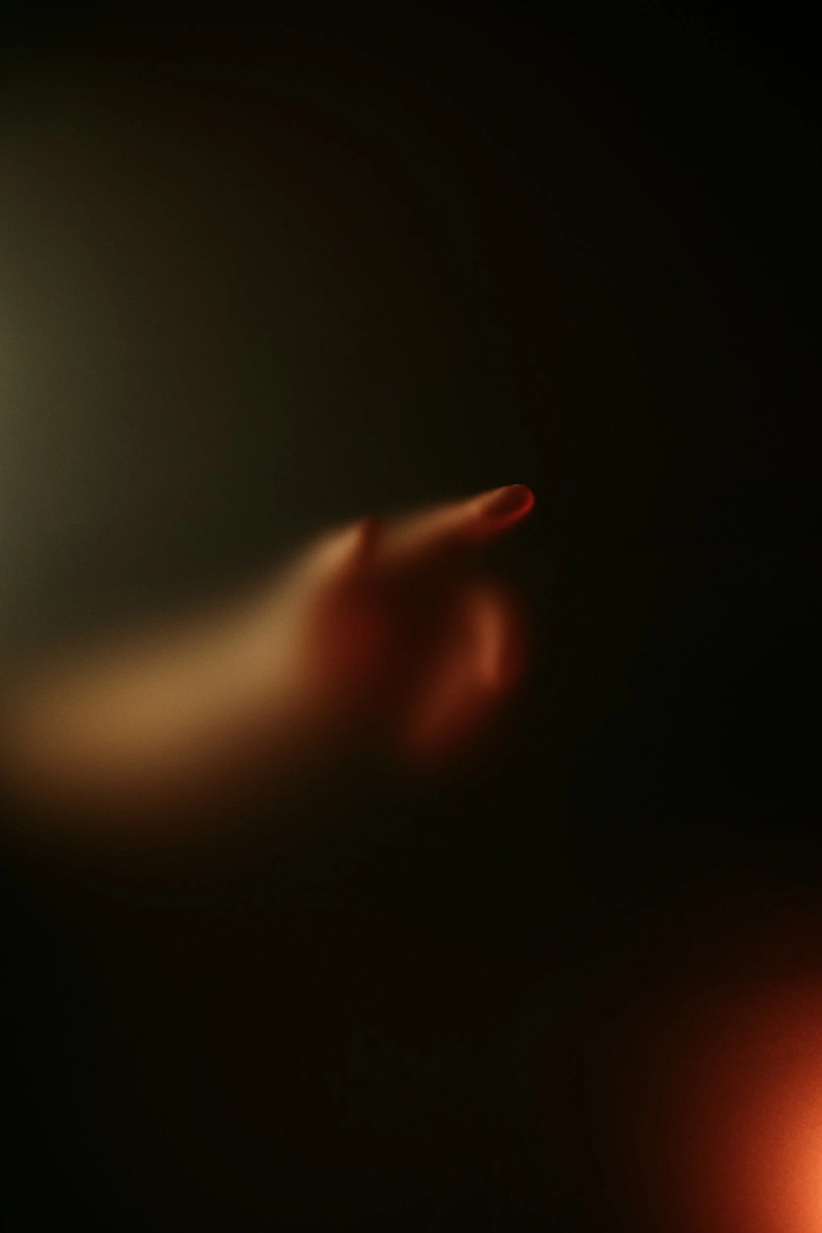 Hand touching blurred glass from the other side