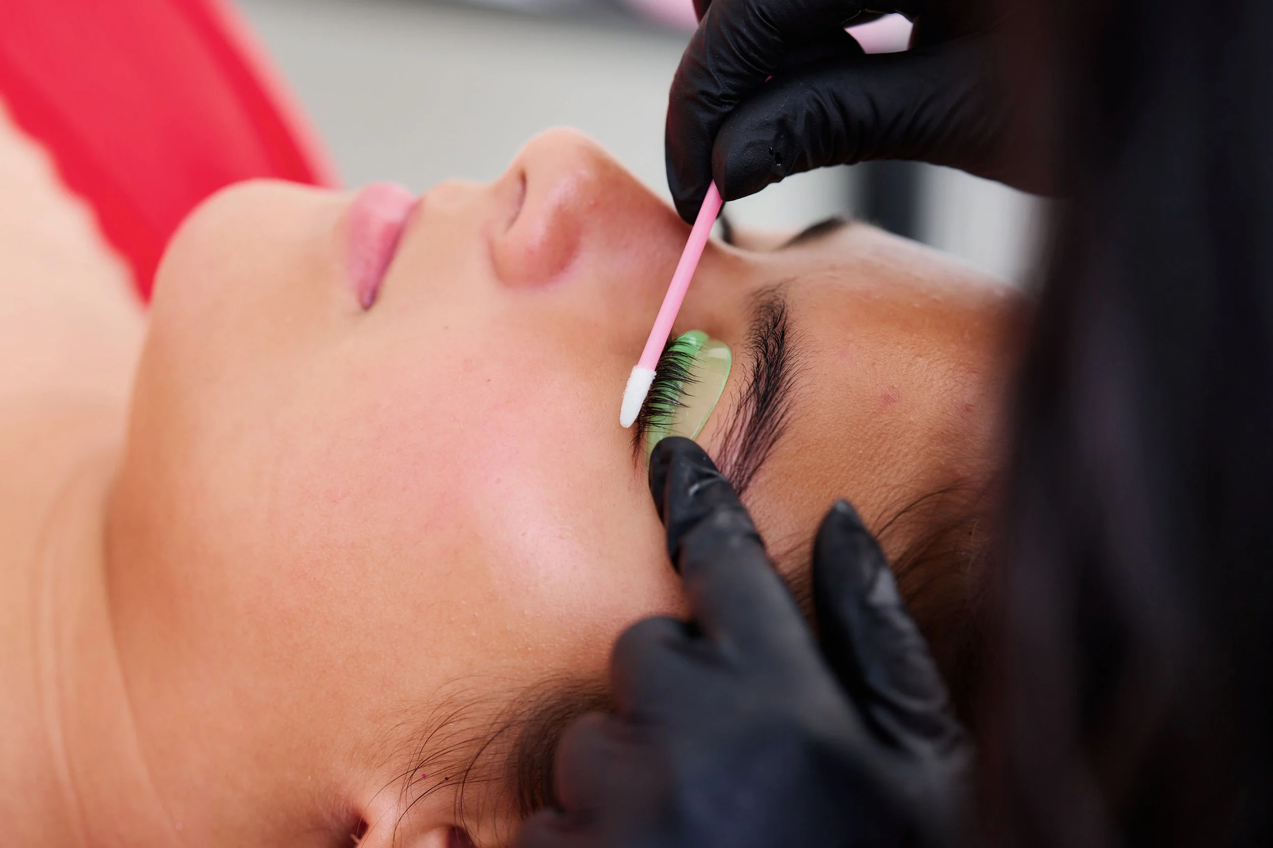 Closeup of a woman's face receiving a lash lift service