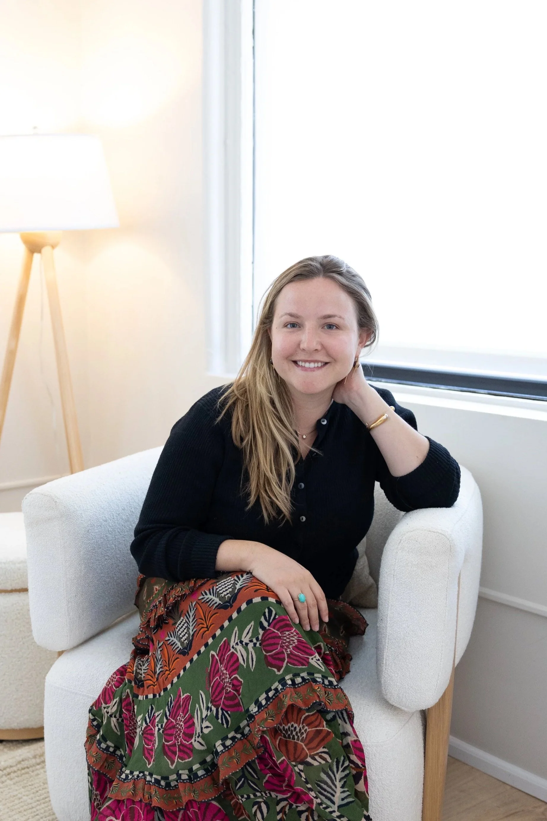 Meghan Lacy Sex Therapist NYC Sitting on a white chair in her office