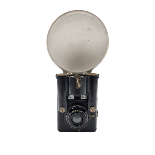 An antique black camera with a circular lens, open silver metal cover, and vintage design.