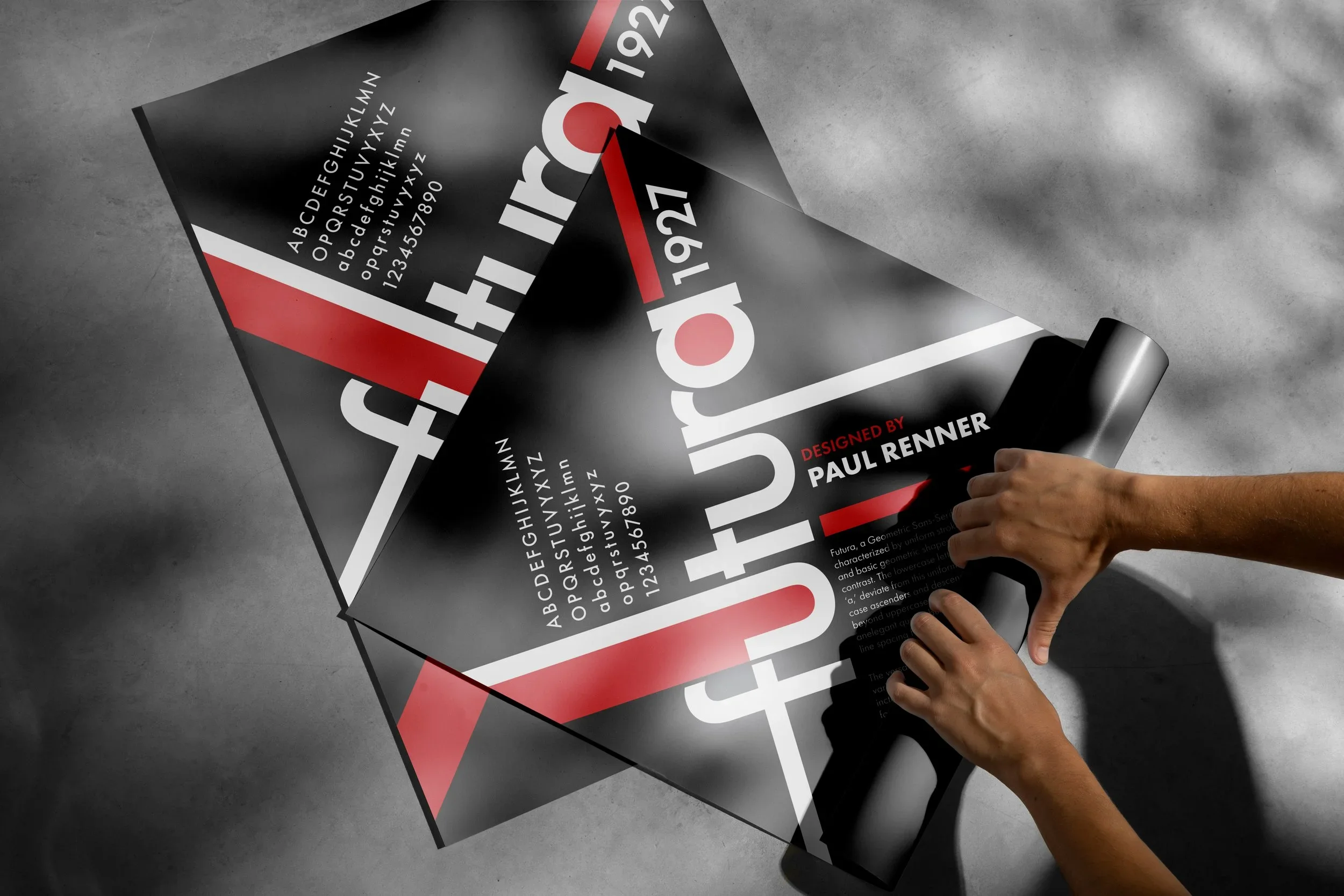 Person applying a black poster with red and white text and graphics on gray surface.
