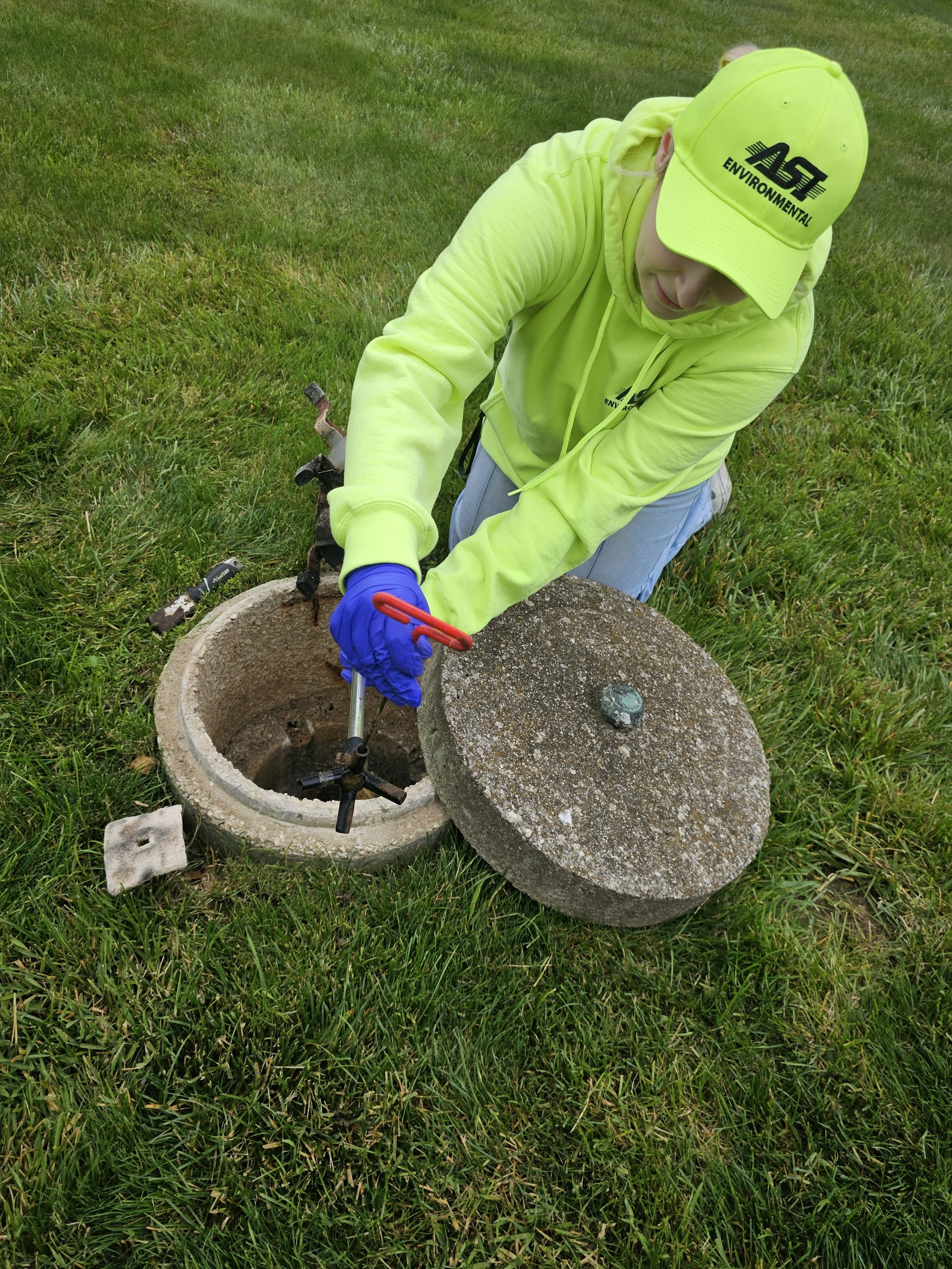 ASI residential division service professional servicing a septic system during a routine maintenance inspection