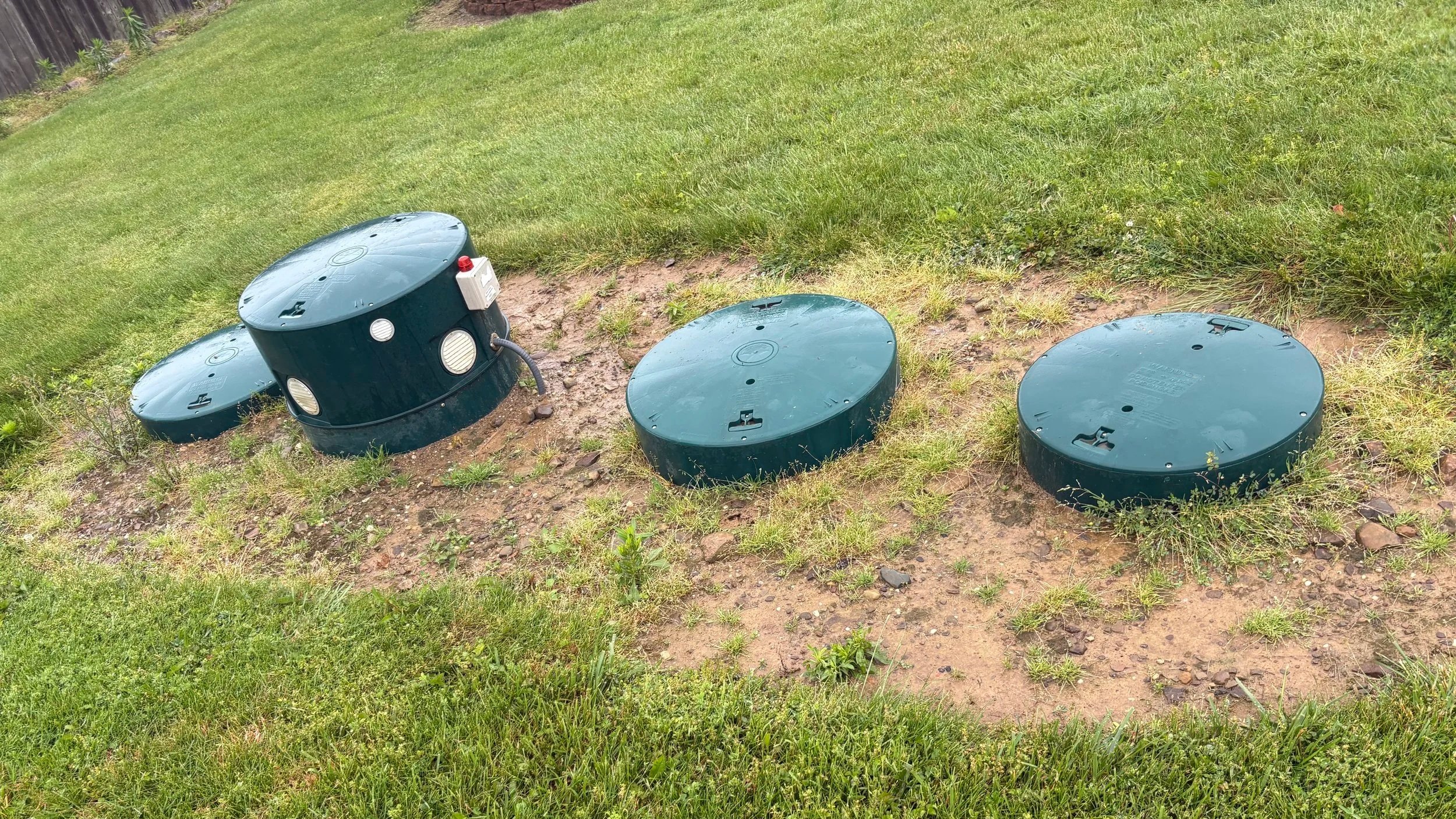 ASI septic system with four green lids and control panel