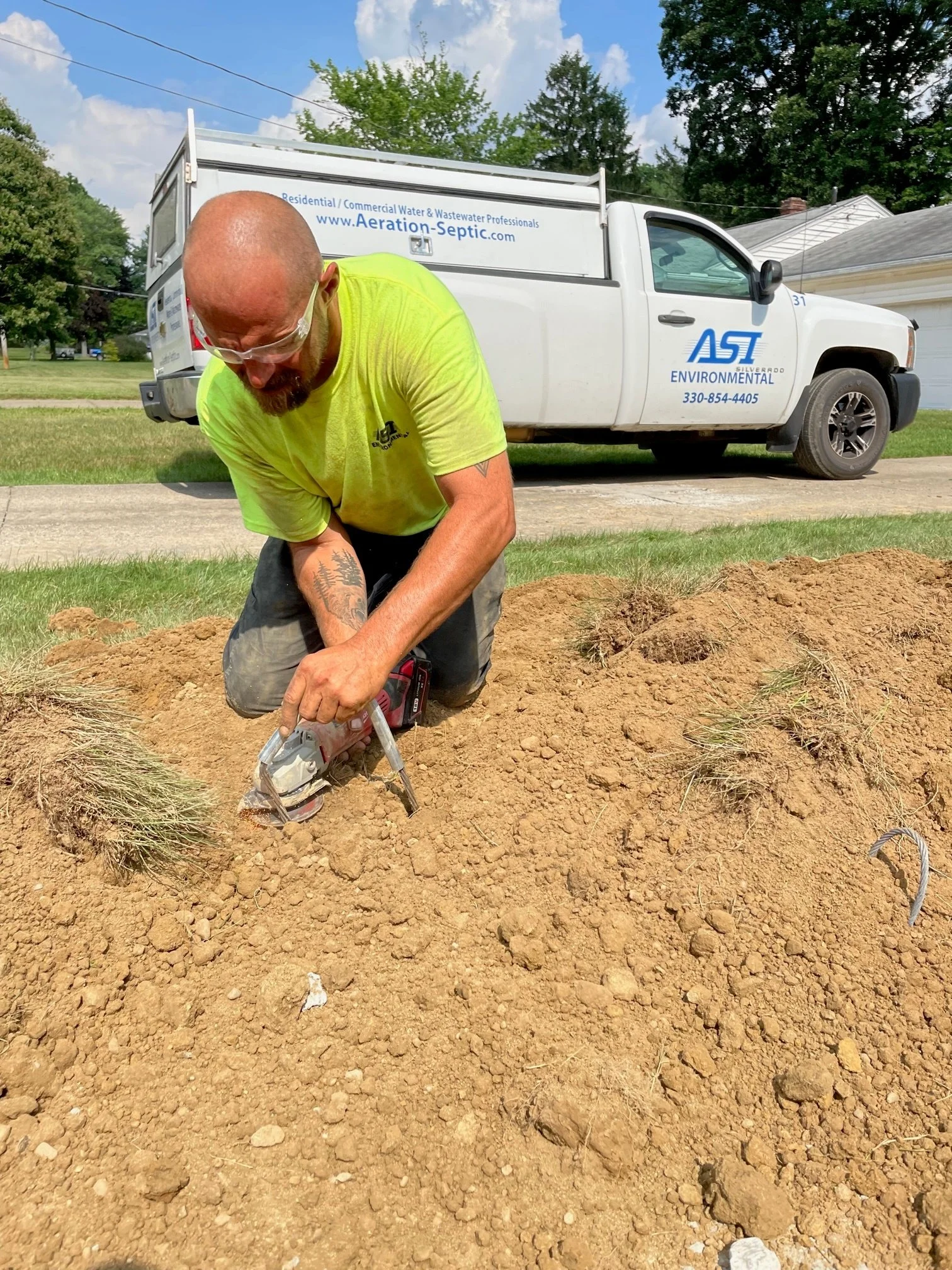 ASI residential division service professional hand digging during a job