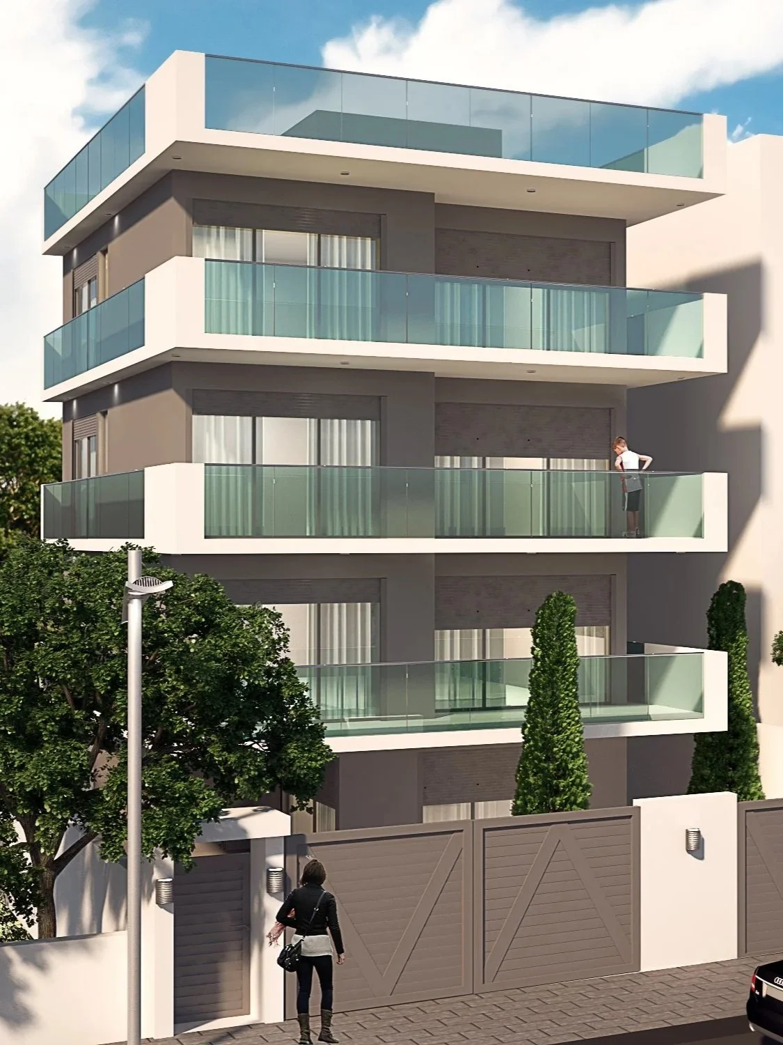 Modern multi-story apartment building with glass balconies, a person standing on the balcony, a woman walking on the sidewalk, trees, and a streetlamp outside.