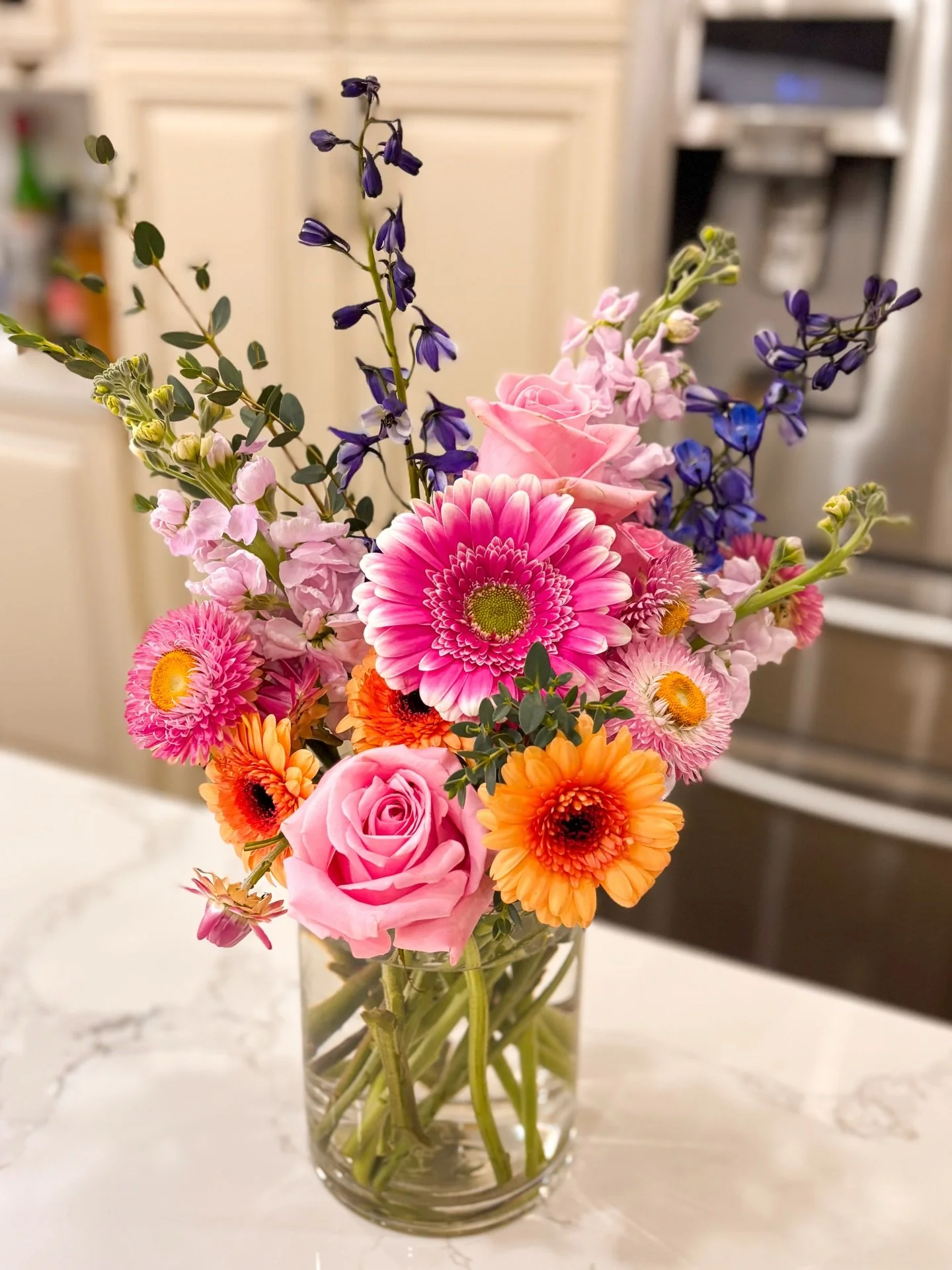 Shifting gears into spring ⚙️ 🍃 🌼 
A little colour bomb action here to celebrate.
This baby is vibrant with pink roses and stock, dark blue delphi,  complemented with an array of gerberas.

There&rsquo;s nothing quite as joyful like the first arran