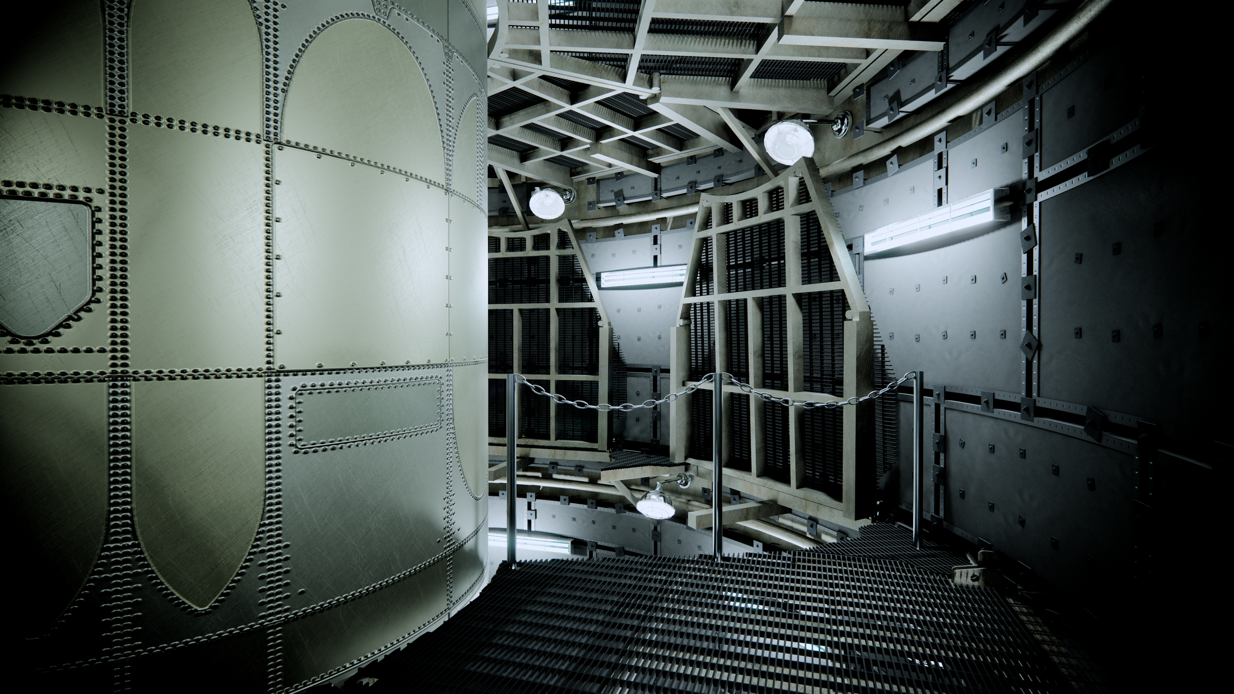 Interior of a large industrial or scientific facility with metallic walls, grates, and pipes, featuring a chain barrier, illuminated by fluorescent lights.