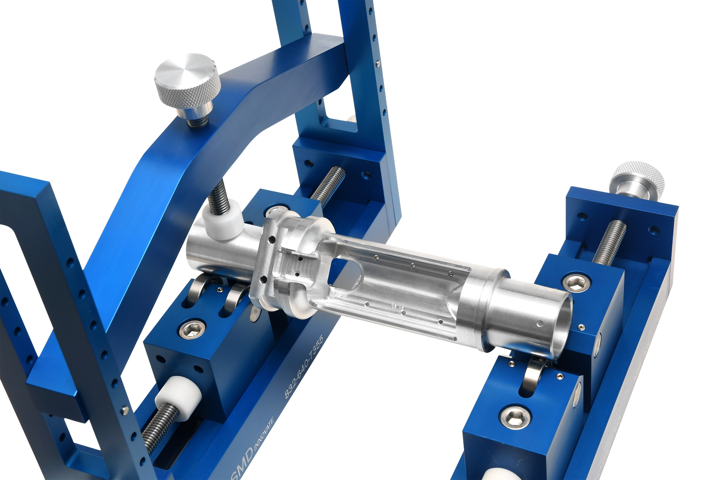 Close-up of adjustable roller V block showing steel rollers and precision mounting hardware
