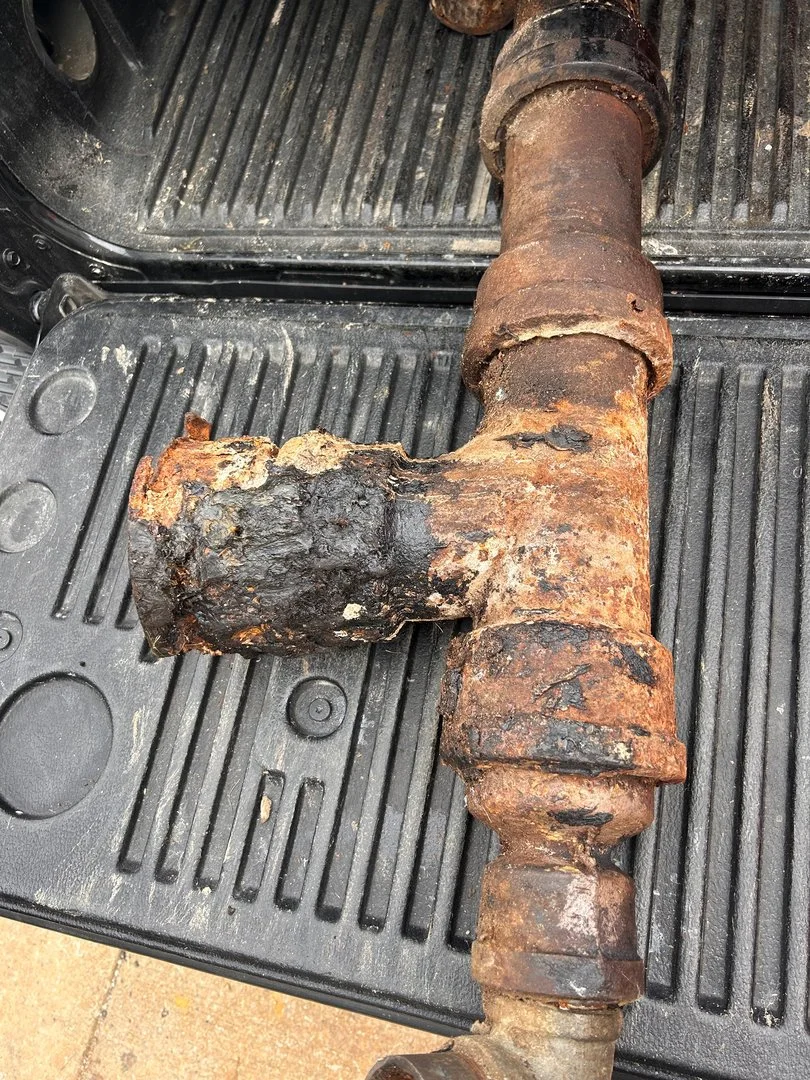 Corroded cast iron drain pipe tee removed from a home