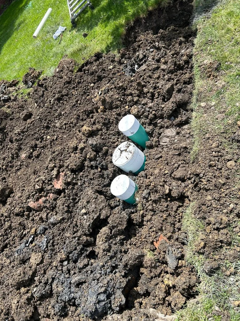 New PVC sewer line with a cleanout tee in a residential yard trench