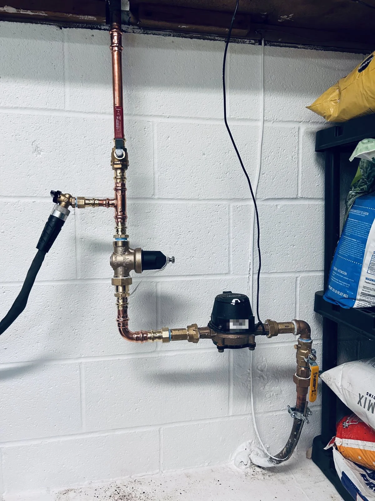 Residential water service with meter, pressure-reducing valve and hose bibb drain on new copper piping