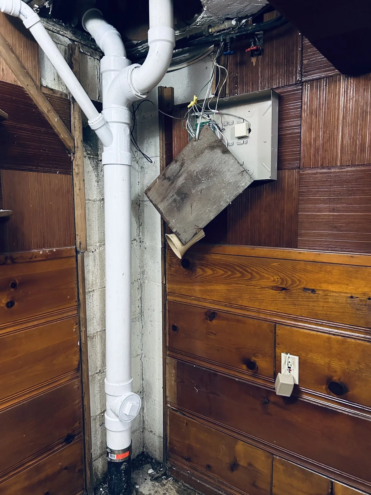 New PVC drain stack with a cleanout in a basement