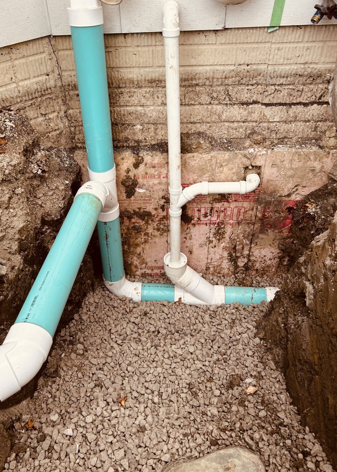 Drain stack and cleanout connection at a home's foundation