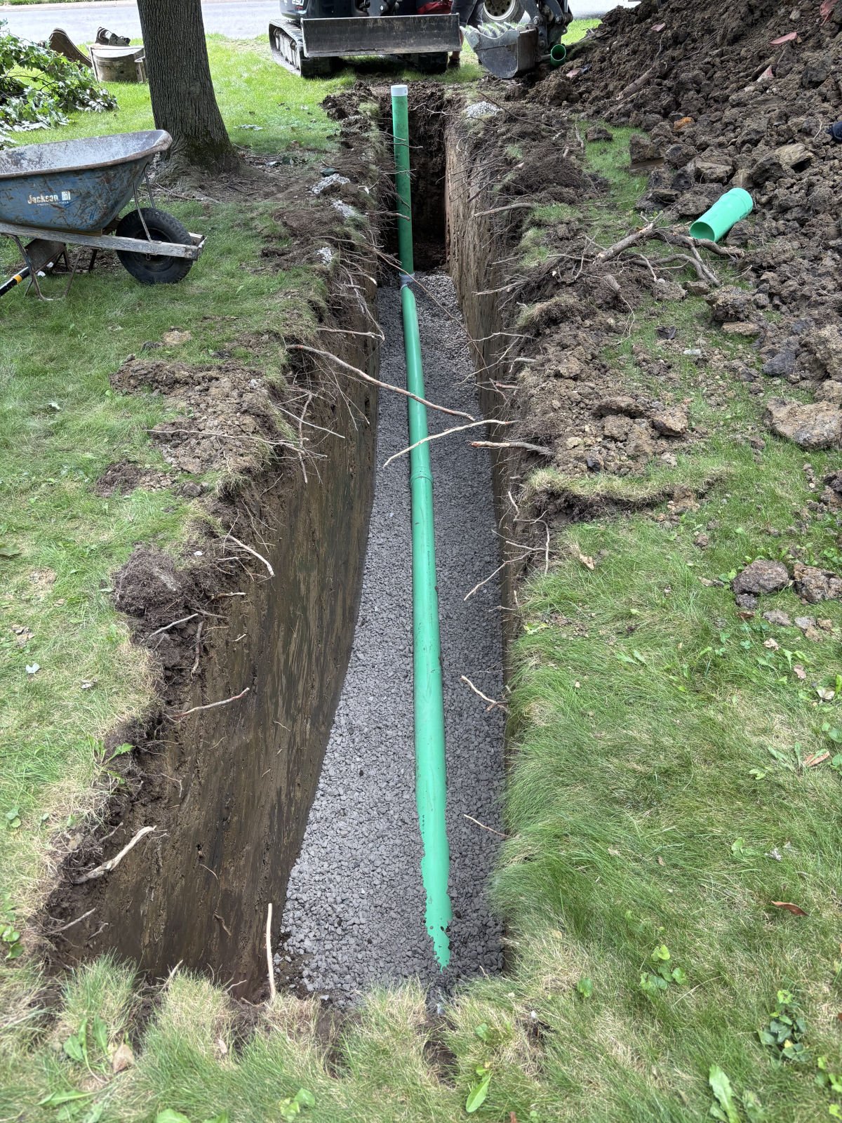 New sewer line laid in a yard trench before backfill