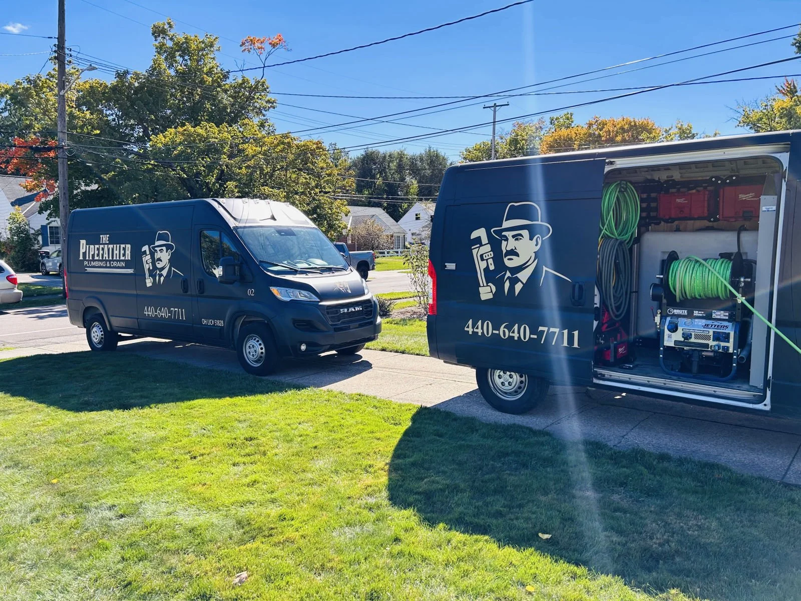 Two Pipefather service vans parked at a job site