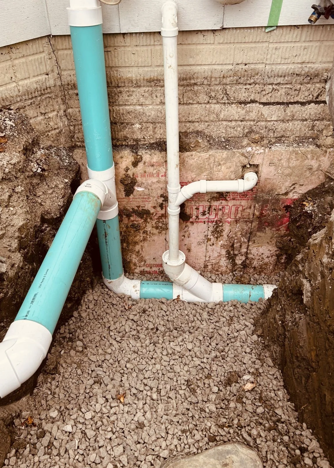 Drain stack and cleanout connection at a home's foundation